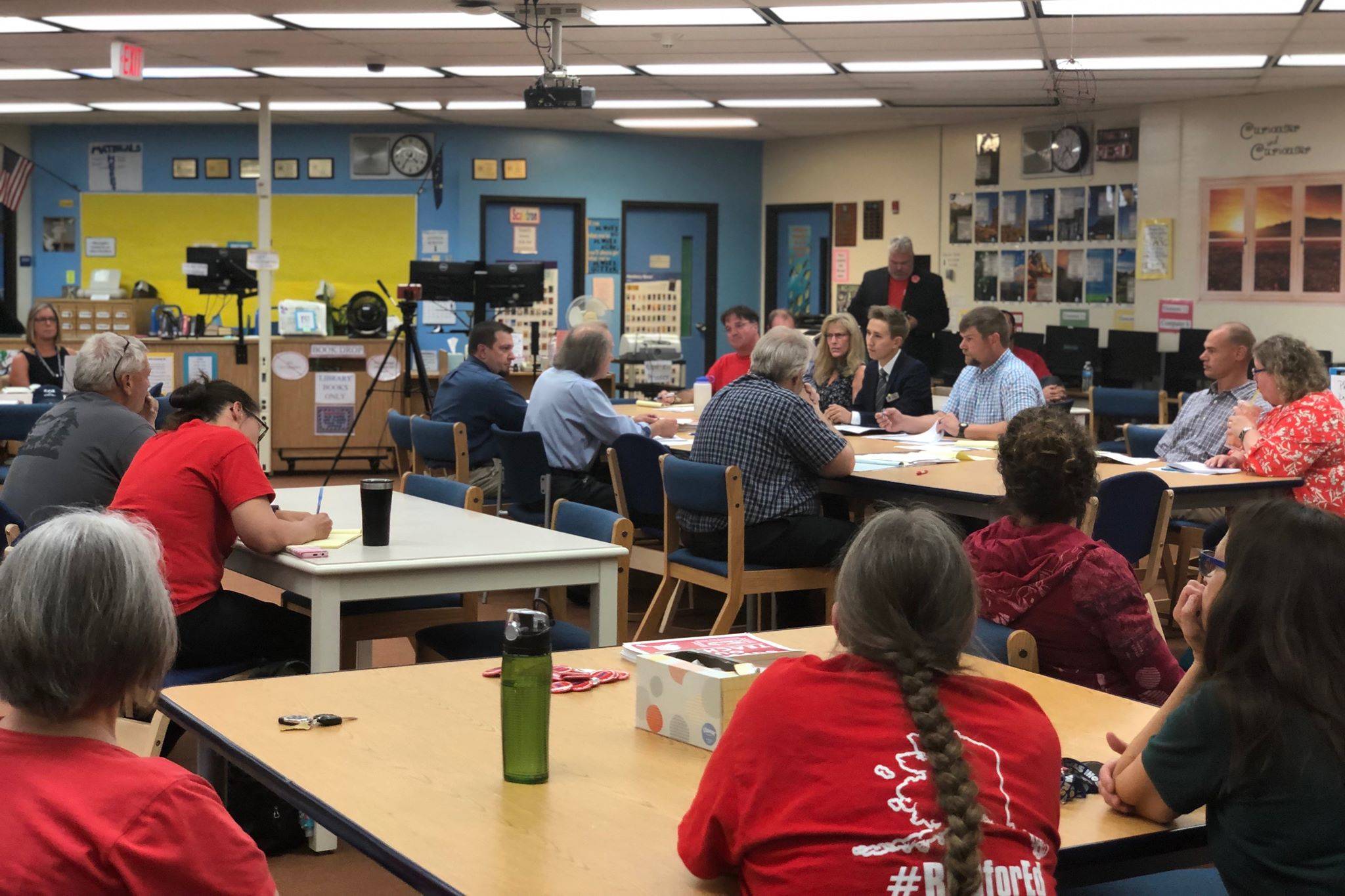 About 75 educators and employees from the Kenai Peninsula Borough School District listen as two employee associations and the district negotiate for a new contract, on Tuesday, Aug. 27, 2019, at the Soldotna High School Library in Soldotna, Alaska. (Photo by Victoria Petersen/Peninsula Clarion)