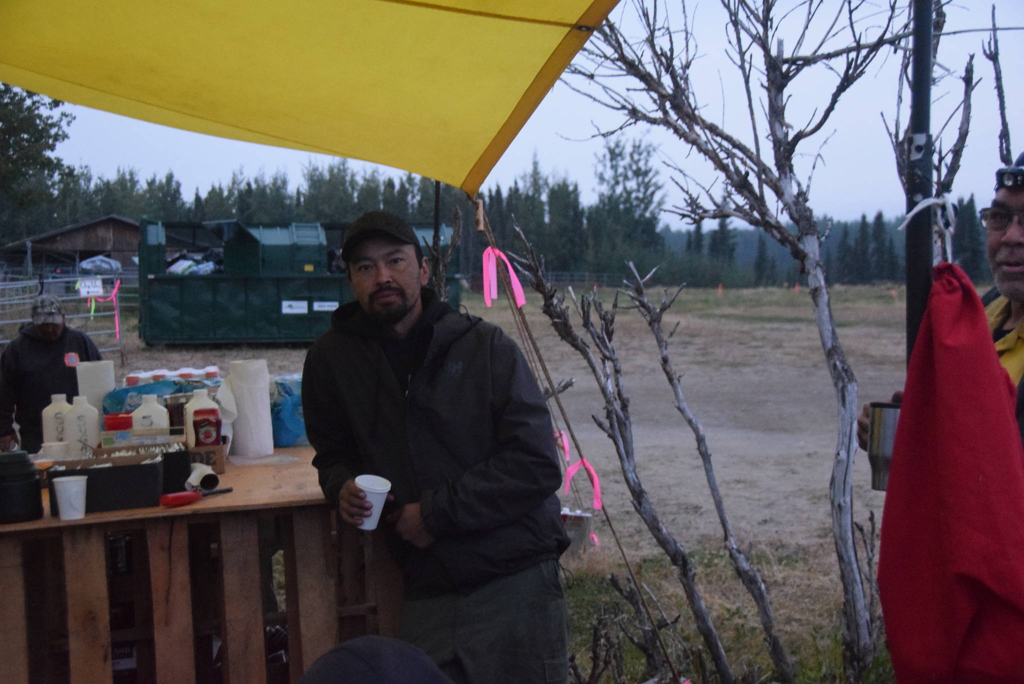 Victor Williams, a firefighter from Ruby, Alaska, drinks his coffee before the morning briefing at the Otter Creek Spike Camp 5 miles north of Sterling, Alaska on Aug. 30, 2019. (Photo by Brian Mazurek/Peninsula Clarion)