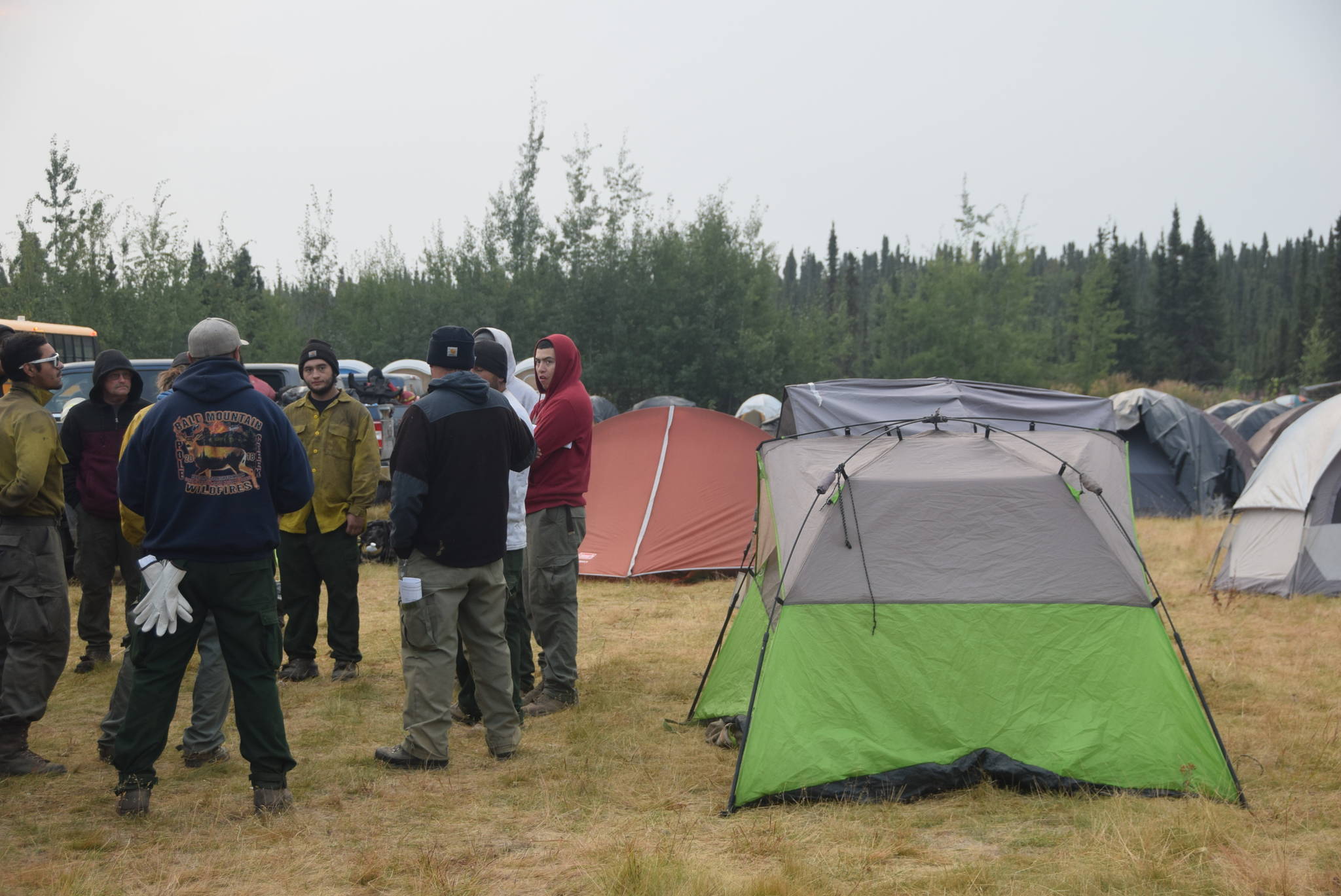 Firefighters discuss the day’s operations during their “division breakout” meeting at the Otter Creek Spike Camp 5 miles north of Sterling, Alaska on Aug. 30, 2019. After the general morning briefing, firefighters meet with their division supervisor to discuss more specifics for the area of the fire to which they are assigned, which is known as a division breakout. (Photo by Brian Mazurek/Peninsula Clarion)