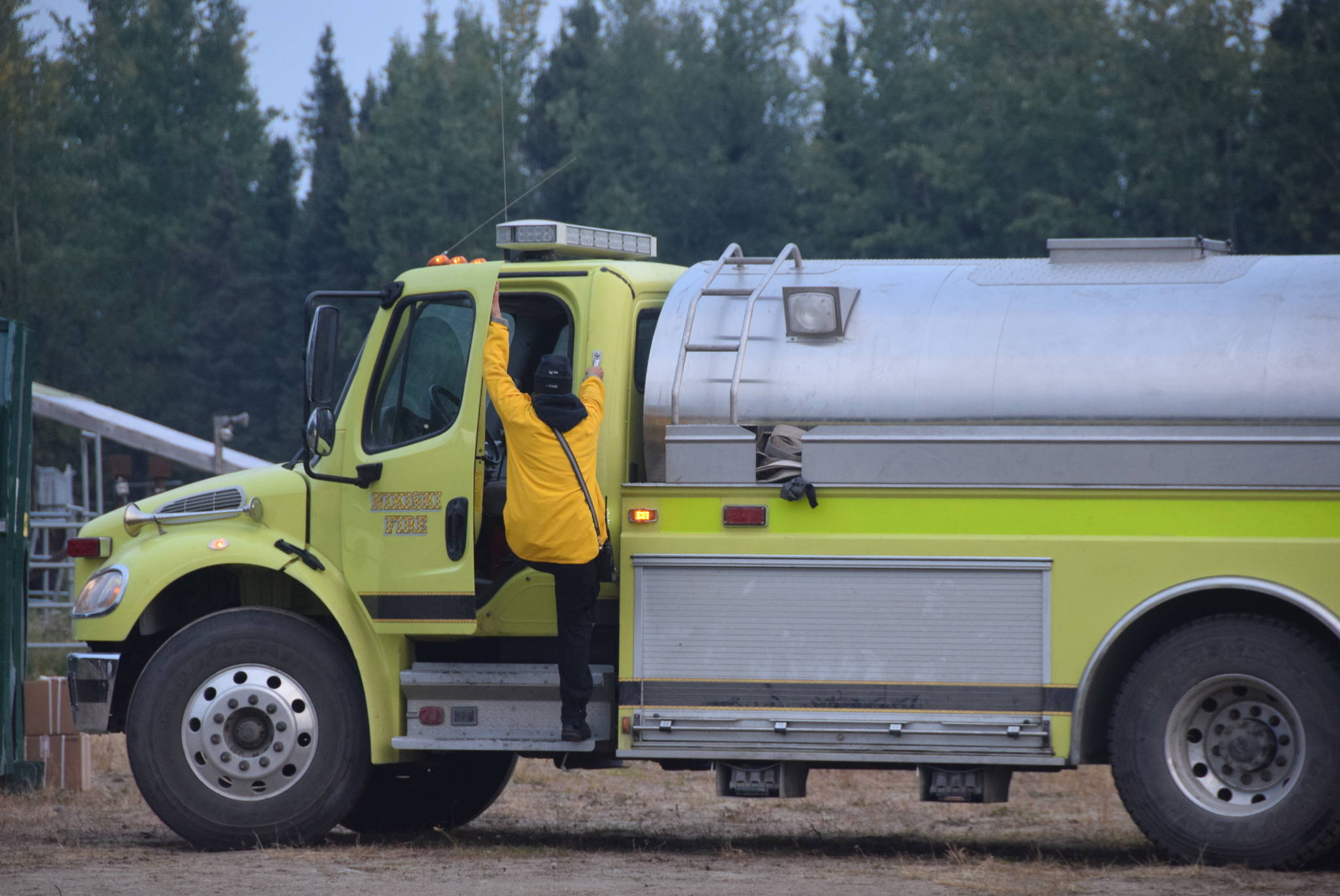 Firefighters load up a tanker from the Nikiski Fire Department at the Otter Creek Spike Camp 5 miles north of Sterling, Alaska on Aug. 30, 2019. (Photo by Brian Mazurek/Peninsula Clarion)