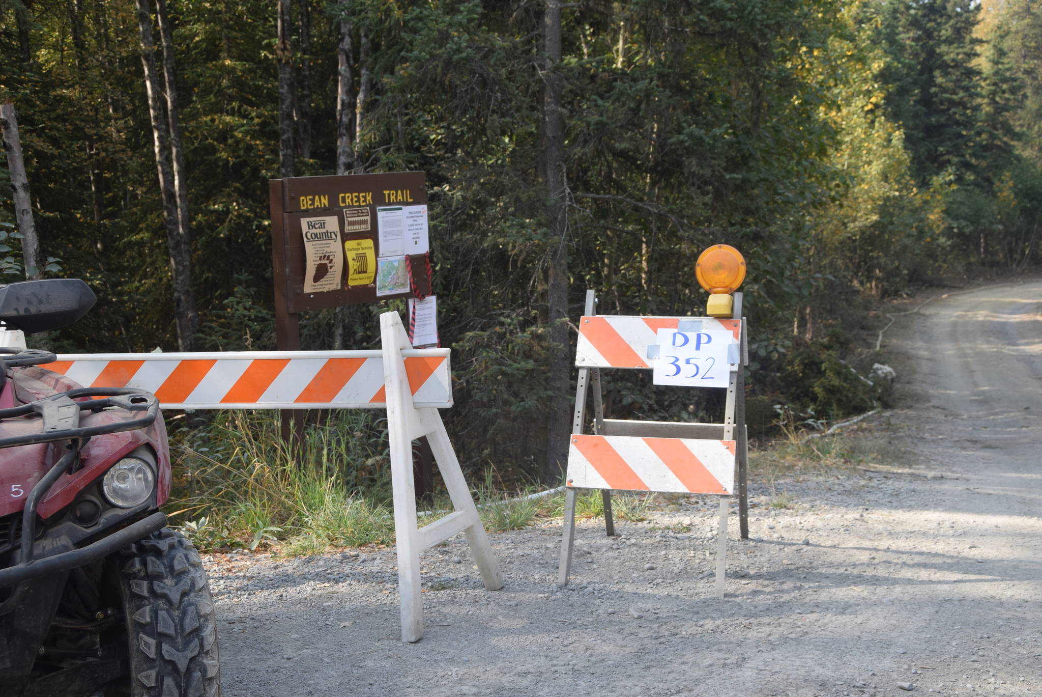 A sign for one of the drop points in Cooper Landing, Alaska can be seen here at the entrance to the Bean Creek Trail on Aug. 30, 2019. Drop points act as meeting points for firefighters working in remote locations and are where supplies such as fuel and spare parts are kept for easy access. (Photo by Brian Mazurek/Peninsula Clarion)
