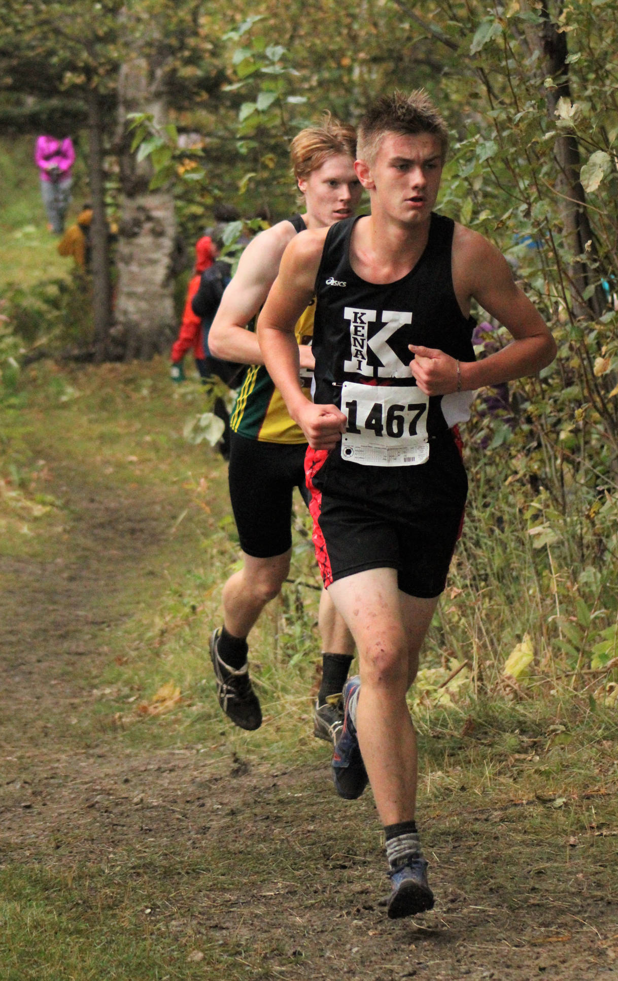 Kenai’s Nathan Haakenson competes during the Division II boys race of the Palmer Invitational. He is in front of Seward’s Max Pfeiffenberger. (Photo by Tim Rockey/Frontiersman)