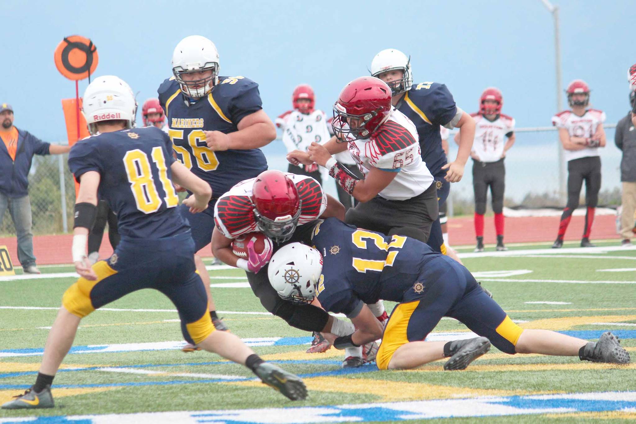 Homer quarterback Anthony Kalugin (12) tackles Houston’s Kennedy Fono during a Friday, Sept. 6, 2019 football game between the two teams on the Mariner field in Homer, Alaska. (Photo by Megan Pacer/Homer News)