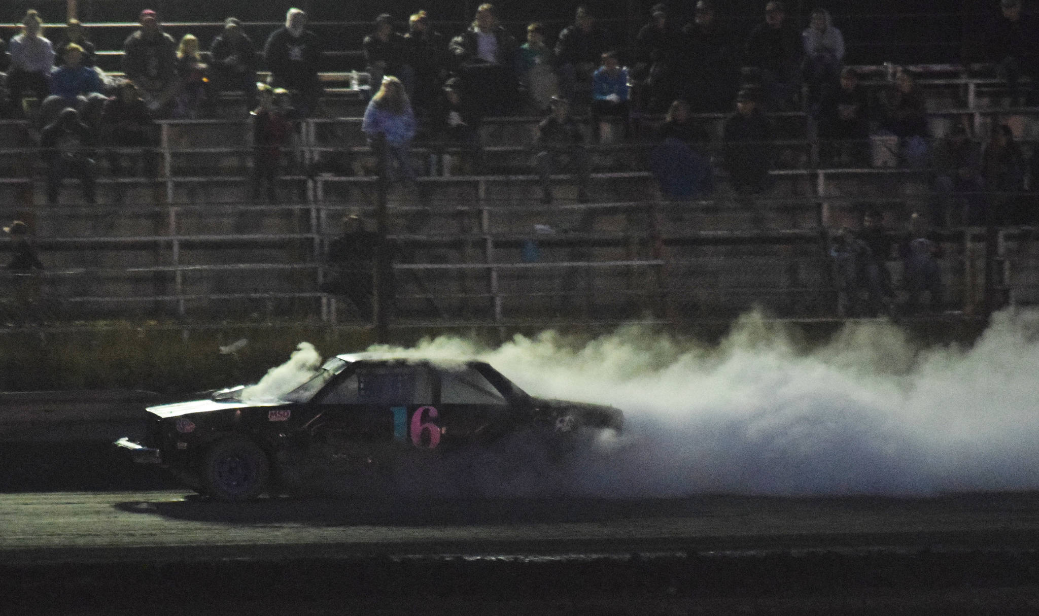 The engine in Gracie Bass’ A-Stock racer expires in spectacular fashion Friday, Sept. 6, 2019, at Twin City Raceway in Kenai, Alaska. (Photo by Joey Klecka/Peninsula Clarion)