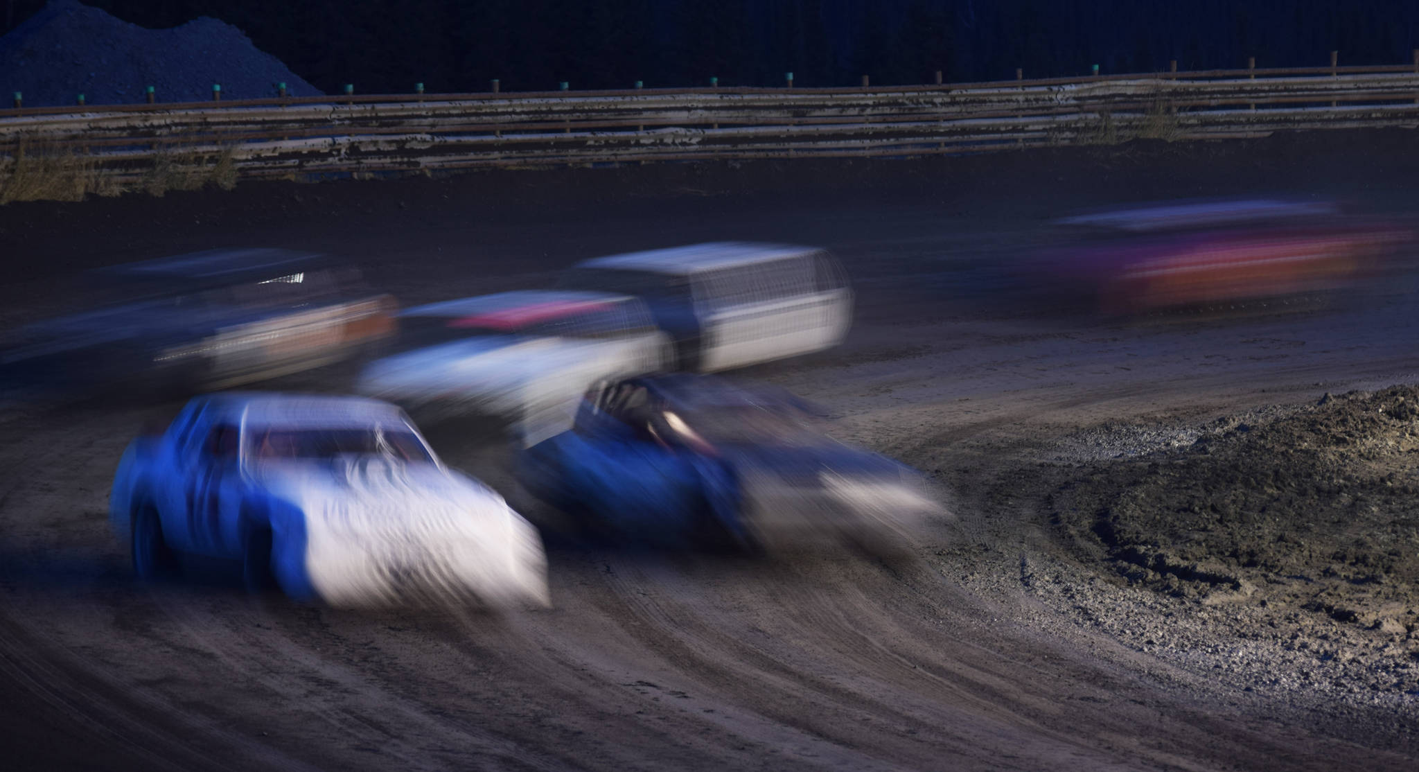 The field of A-Stock racers sweep through turn 2 Friday, Sept. 6, 2019, at Twin City Raceway in Kenai, Alaska. (Photo by Joey Klecka/Peninsula Clarion)