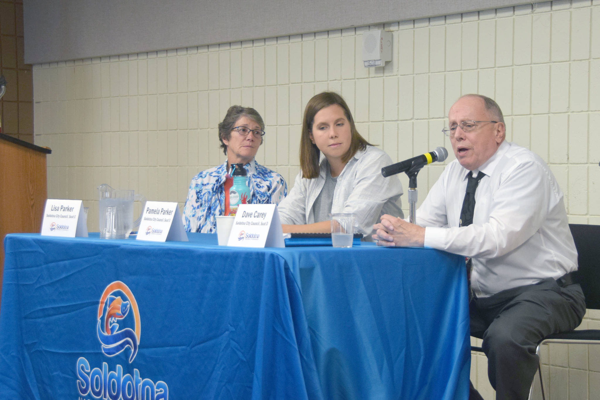 Soldotna City Council candidates Lisa Parker, Pamela Parker and Dave Carey speak to members of the Soldotna Chamber of Commerce at the Soldotna Sports Complex on Wednesday. (Photo by Brian Mazurek/Peninsula Clarion)