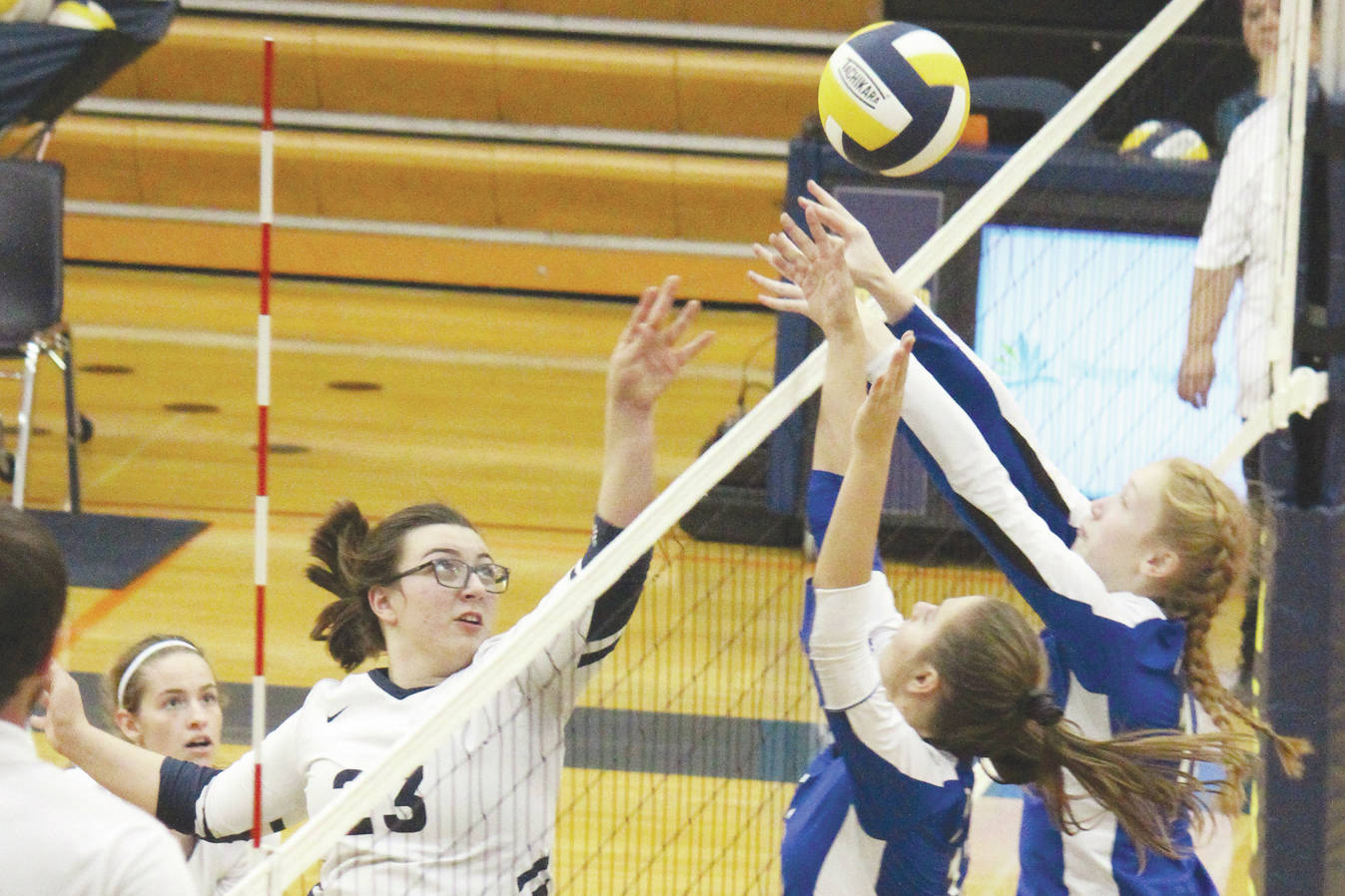 Palmer’s Kristen Beames (center) and Carli Bowen (right) jump to block a tip from Homer’s Tonda Smude during a Thursday, Sept. 12, 2019 volleyball game in the Alive Witte Gymnasium in Homer, Alaska. (Photo by Megan Pacer/Homer News)