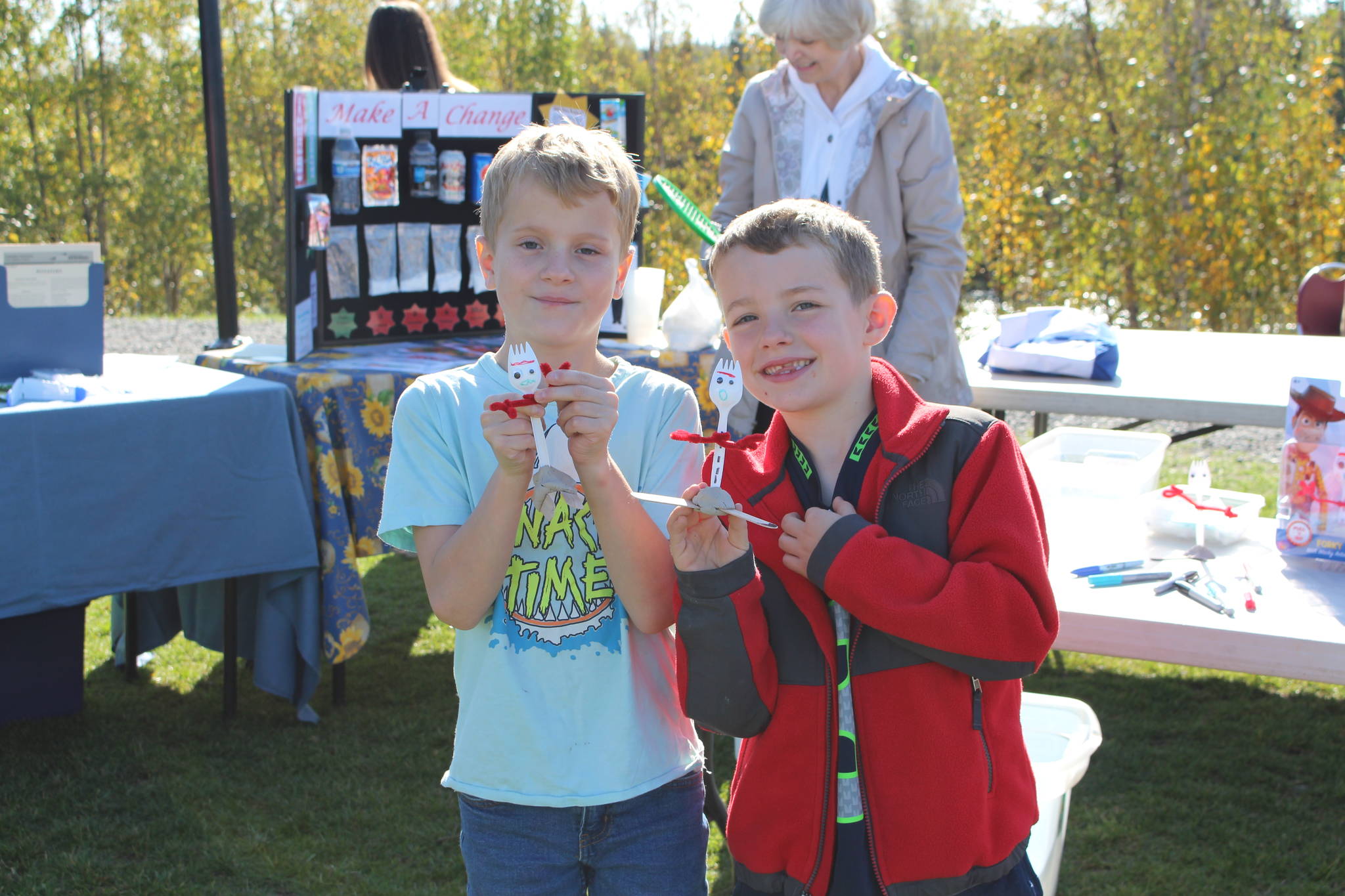 Sage Carricot, left, and Wade Alvore, right, show off their fork figures at the Harvest Moon Local Food Festival at Soldotna Creek Park on Sept. 14, 2019. (Photo by Brian Mazurek/Peninsula Clarion)