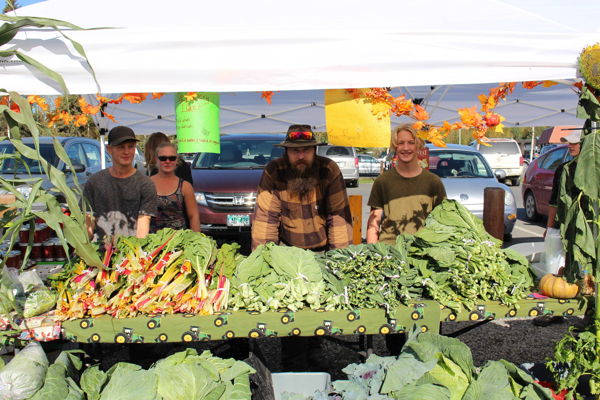 John Land, Christina Land, Joshua Land and Edgar Land of Grace Acres Farm show off some of their produce at the Harvest Moon Local Food Festival at Soldotna Creek Park on Sept. 14, 2019. (Photo by Brian Mazurek/Peninsula Clarion)