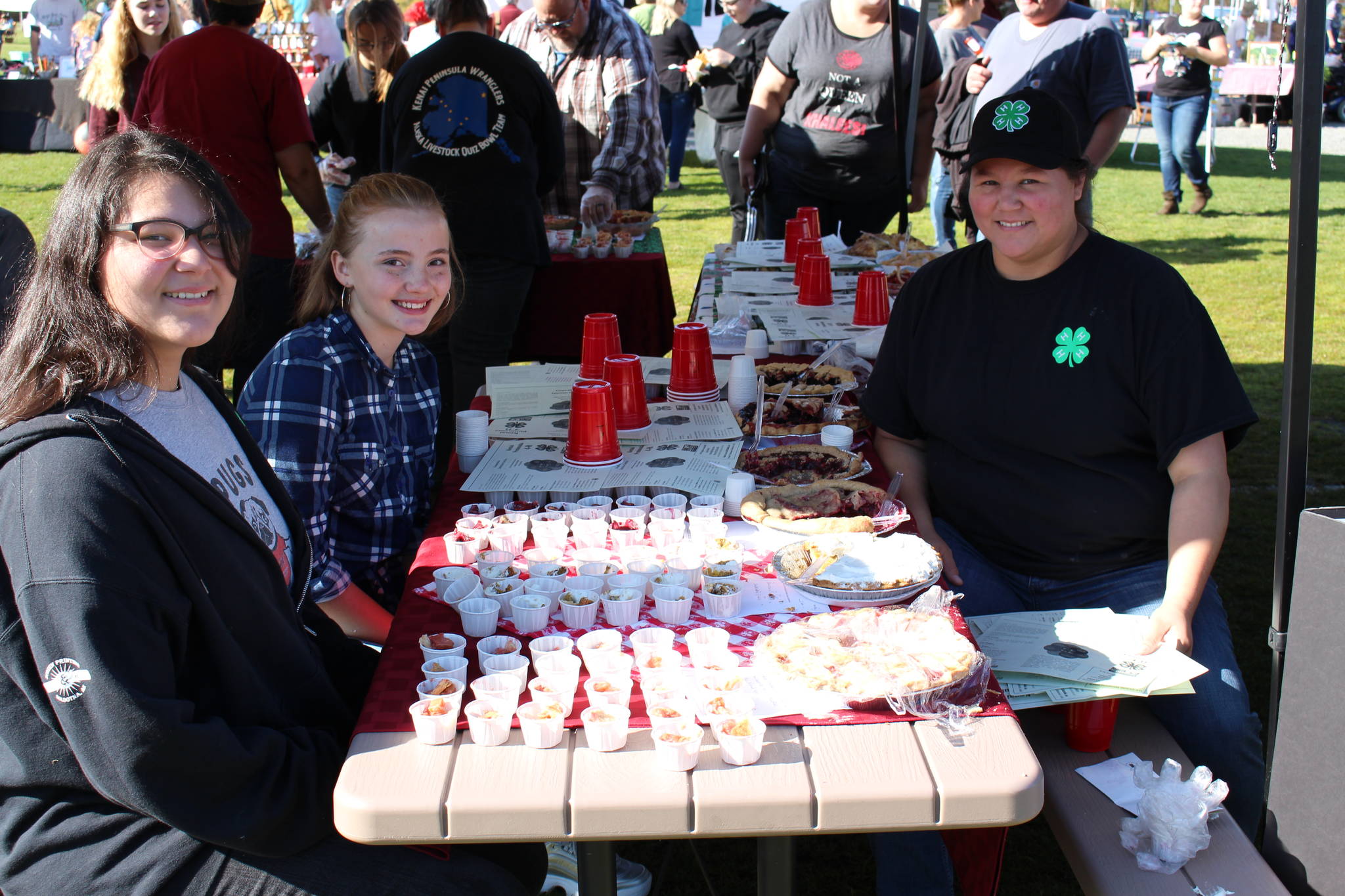 From left, Tina Uta, Melanie Carpenter and Becky Uta prepare pie samples for the people’s choice pie contest at the Harvest Moon Local Food Festival at Soldotna Creek Park on Sept. 14, 2019. (Photo by Brian Mazurek/Peninsula Clarion)