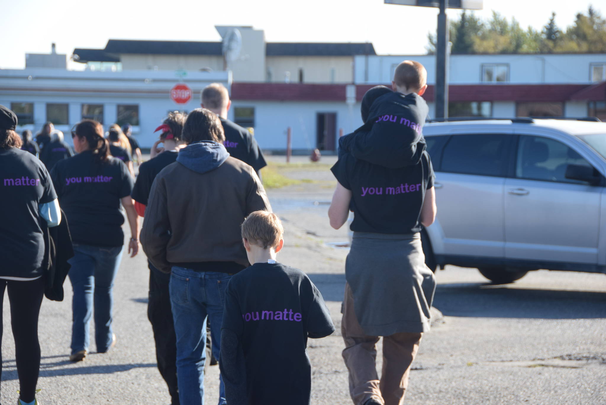 Participants in the You Matter. L;ve Suicide Awareness and Prevention Walk can be seen here walking through Old Town Kenai on Saturday, Sept. 14, 2019. (Photo by Brian Mazurek/Peninsula Clarion)