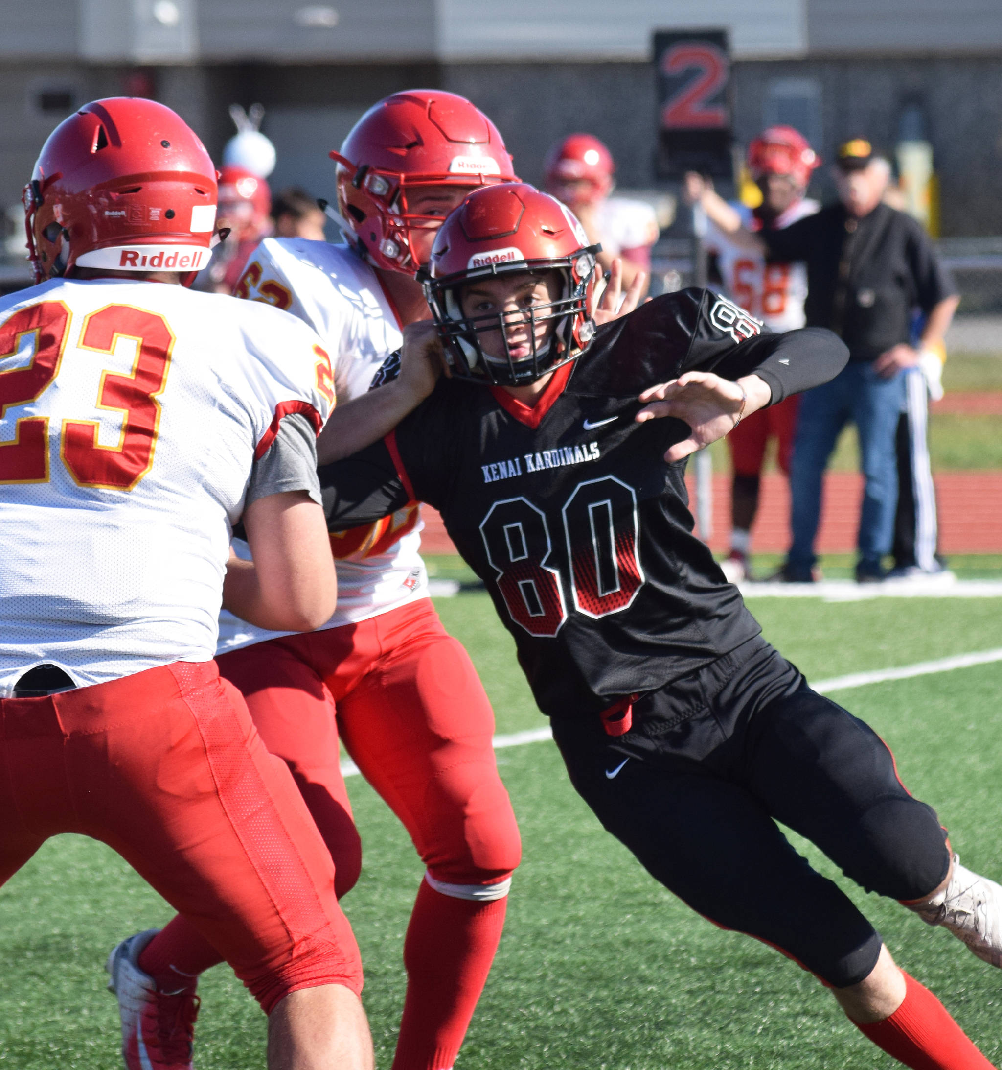 Kenai Central defender Corvin Bookey (80) pressures West Valley quarterback Shaun Conwell, Saturday, Sept. 14, 2019, at Ed Hollier Field in Kenai, Alaska. (Photo by Joey Klecka/Peninsula Clarion)