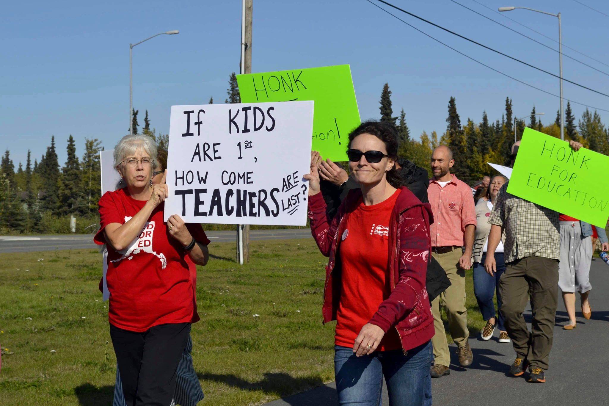 Educators rally in front of Kenai Central High School ahead of a strike slated to begin Tuesday, on Monday, Sept. 16, 2019, in Kenai, Alaska. (Photo by Victoria Petersen/Peninsula Clarion)