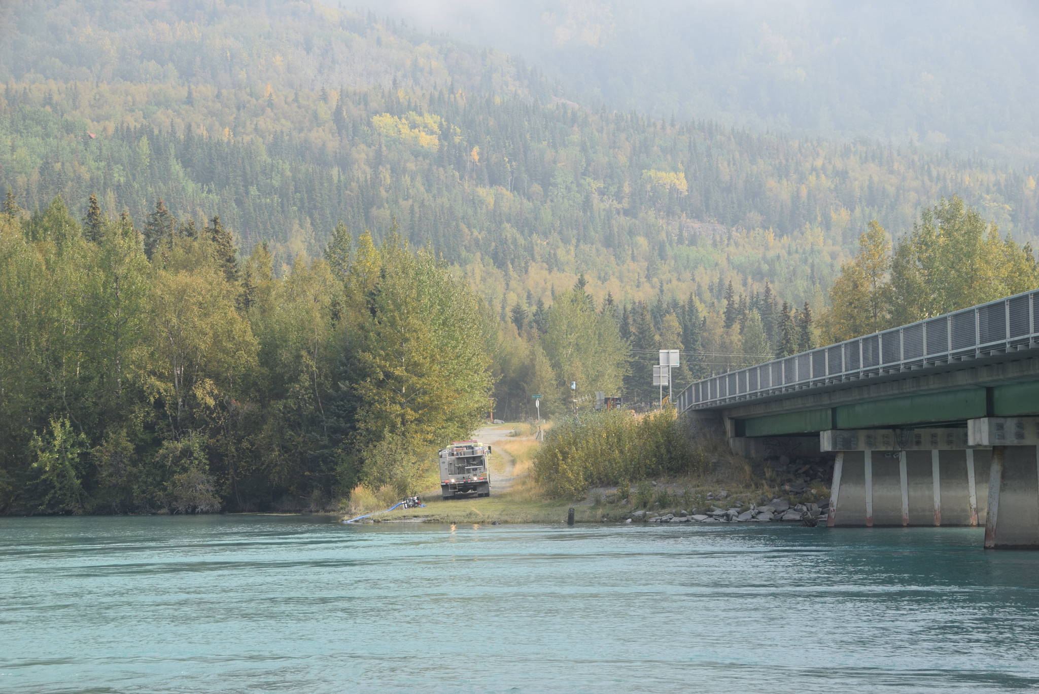 Firefighters refill their water tanker along the banks of the Kenai River in Cooper Landing, Alaska on Aug. 30, 2019. (Photo by Brian Mazurek/Peninsula Clarion)