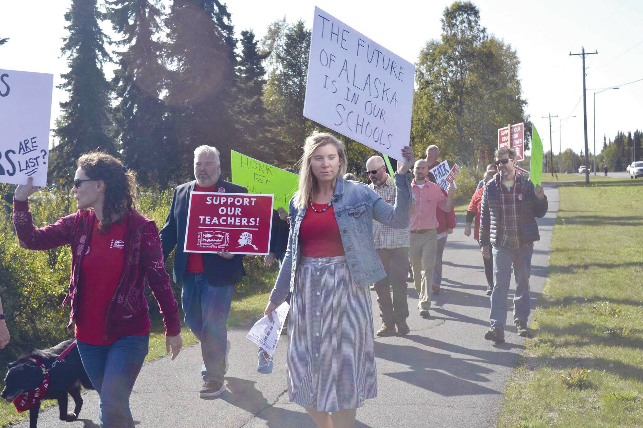 Educators rally ahead of a 7 a.m. Tuesday strike deadline on Monday in front of Kenai Central High School. The two teachers associations and the school district reached an agreement Tuesday morning — just hours before the strike deadline. (Photo by Victoria Petersen/Peninsula Clarion)