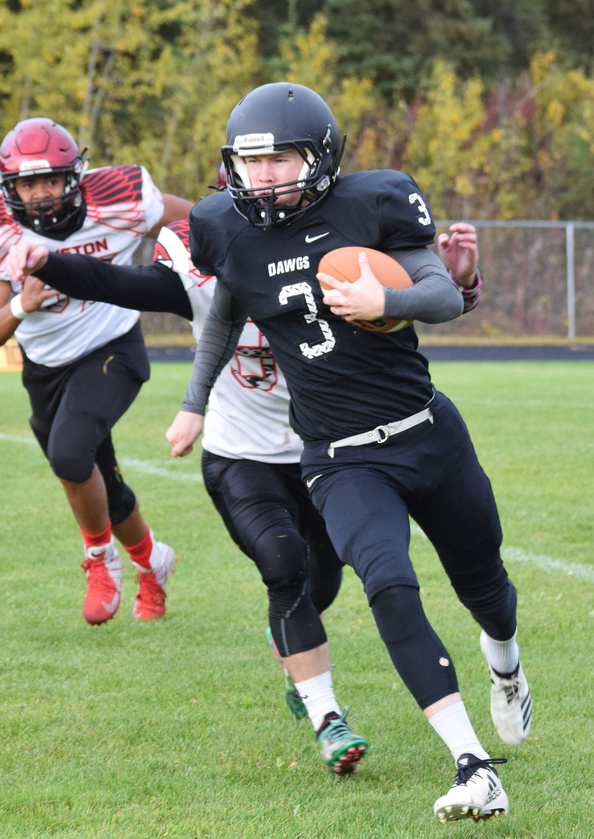 Nikiski running back Sam Berry carries the ball against Houston, Friday, Sept. 20, 2019, at Nikiski High School. (Photo by Joey Klecka/Peninsula Clarion)