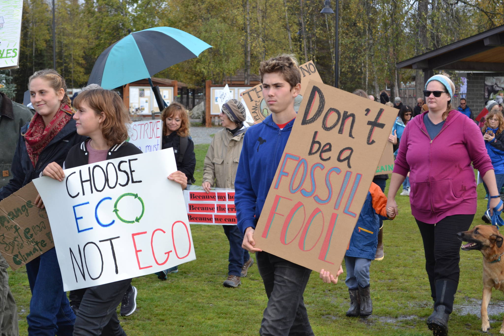 Marchers in the Soldotna Climate Strike walk through Soldotna Creek Park toward the Sterling Highway on Sept. 20, 2019. (Photo by Brian Mazurek/Peninsula Clarion)