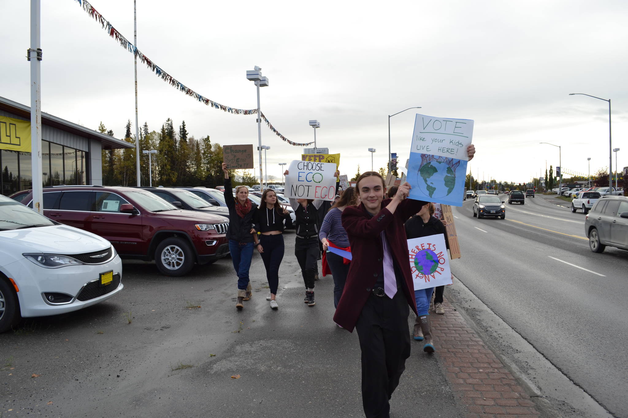 Youth organizer Kaegan Koski leads the participants of the Soldotna Climate Strike down the Sterling Highway in Soldotna, Alaska on Sept. 20, 2019. (Photo by Brian Mazurek/Peninsula Clarion)