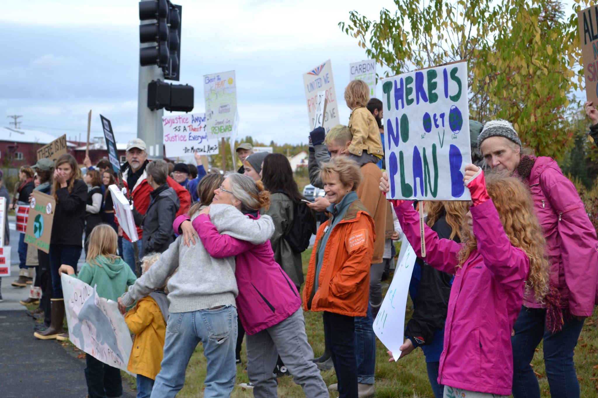 Participants in the Soldotna Climate Strike hold signs at the intersection of the Sterling Highway and the Kenai Spur Highway in Soldotna, Alaska on Sept. 20, 2019. (Photo by Brian Mazurek/Peninsula Clarion)