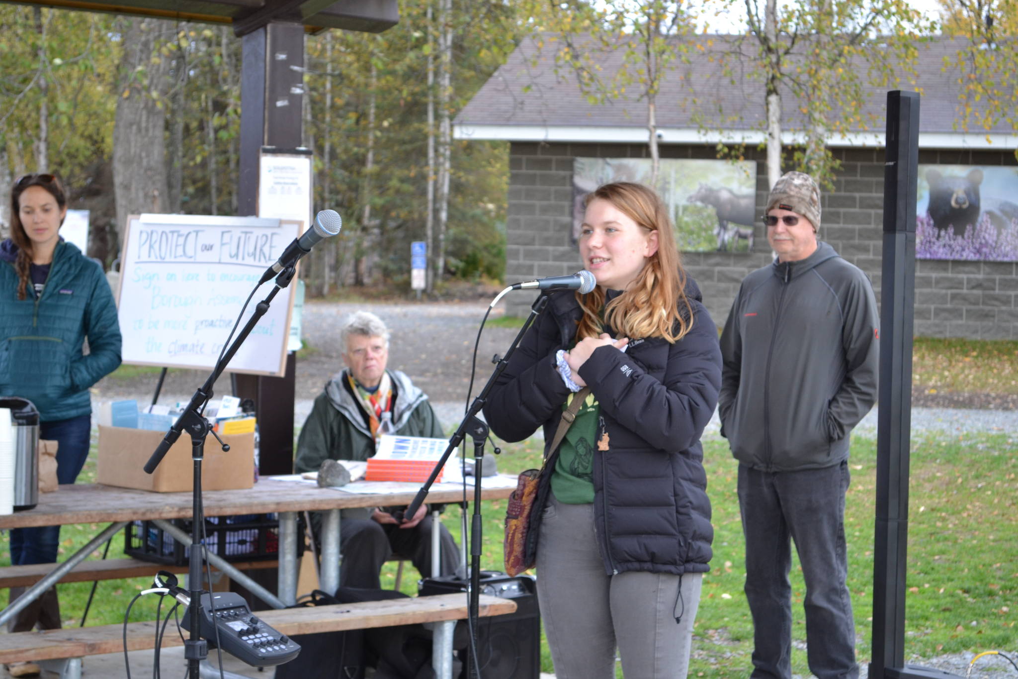 Youth organizer Eve Downing speaks to participants in the Soldotna Climate Strike at Soldotna Creek Park on Sept. 20, 2019. (Photo by Brian Mazurek/Peninsula Clarion)