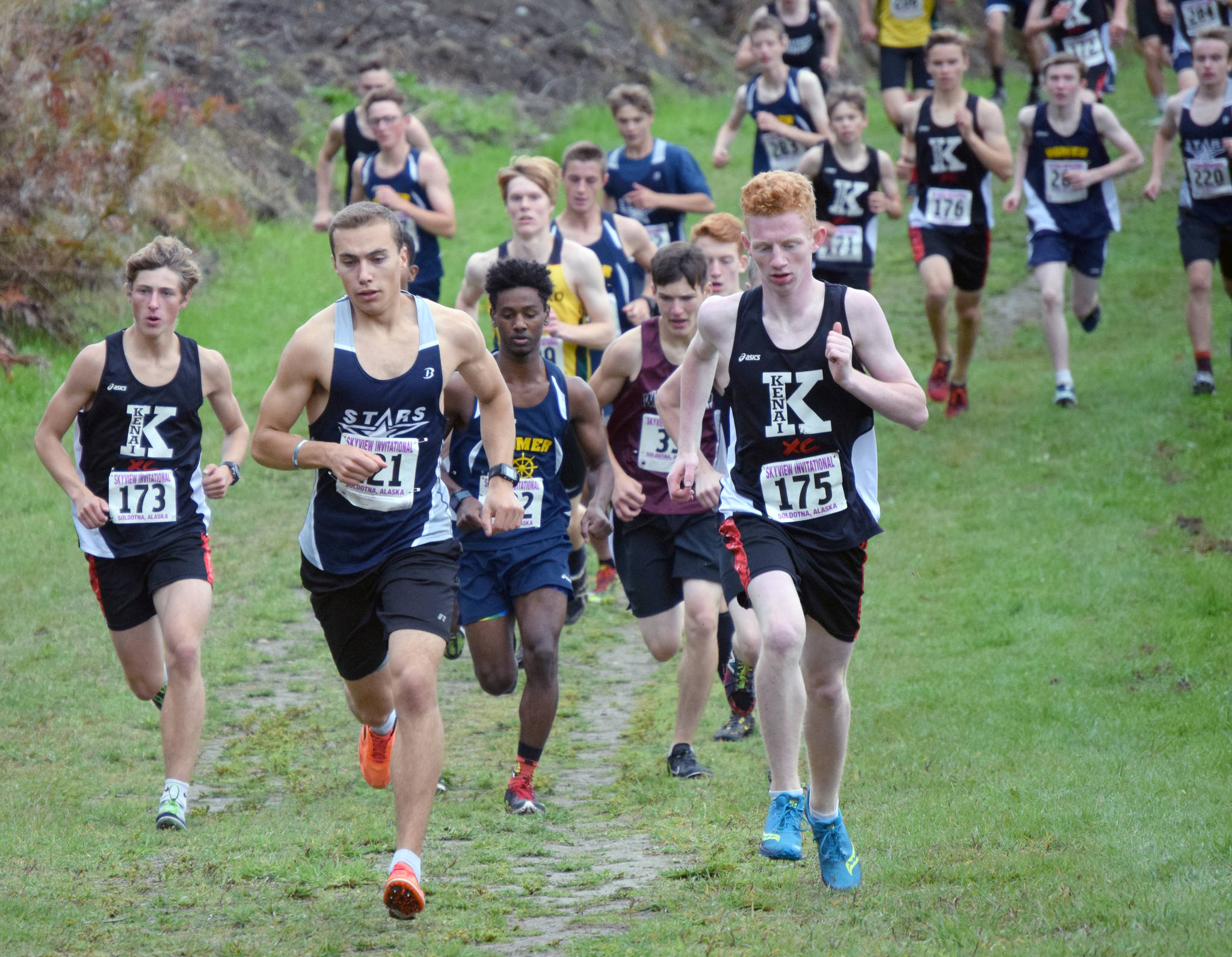 Kenai Central’s Maison Dunham (173), Soldotna’s Bradley Walters and Kenai’s Joe Hamilton lead the boys varsity field at the start of the Kenai Peninsula Borough cross-country meet Saturday at Tsalteshi Trails. (Photo by Jeff Helminiak/Peninsula Clarion)