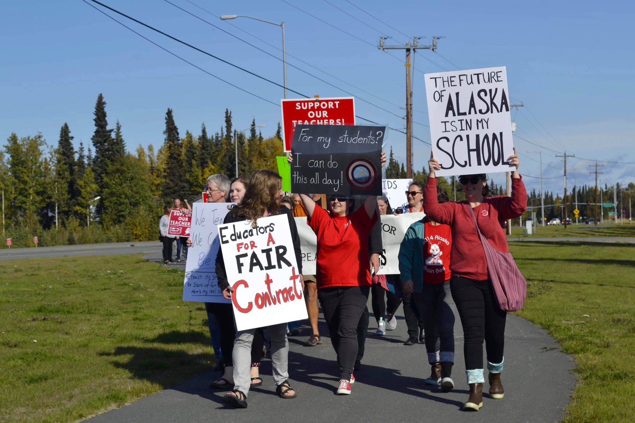 Educators rally in front of Kenai Central High School after school ahead of a strike called on by two employee associations, on Monday, Sept. 16, 2019, in Kenai, Alaska. (Photo by Victoria Petersen/Peninsula Clarion)