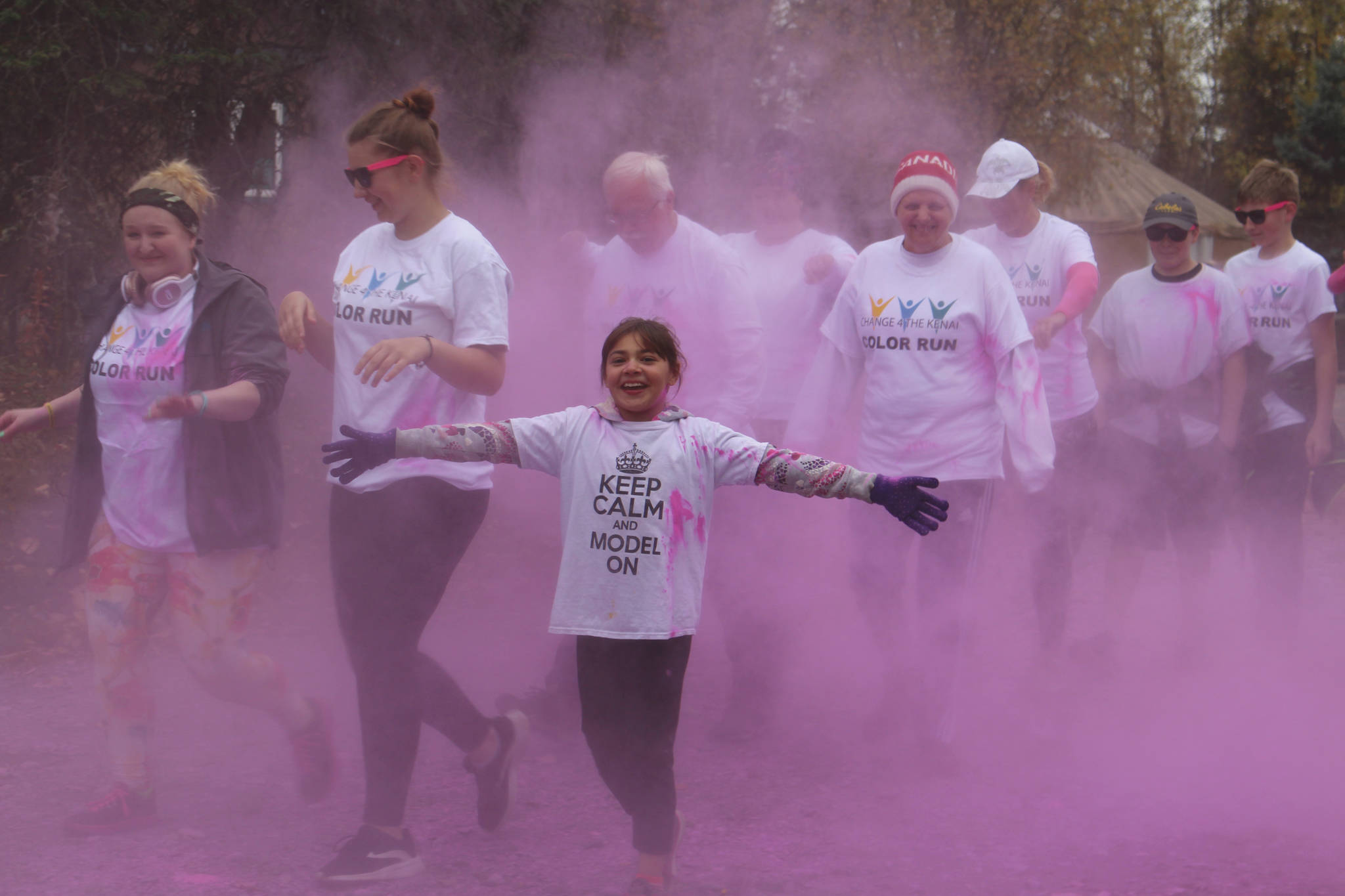 Brian Mazurek / Peninsula Clarion                                Participants in the 2019 Stomp Out Stigma Color Run make their way through a haze of pink chalk at Soldotna Creek Park on Saturday.