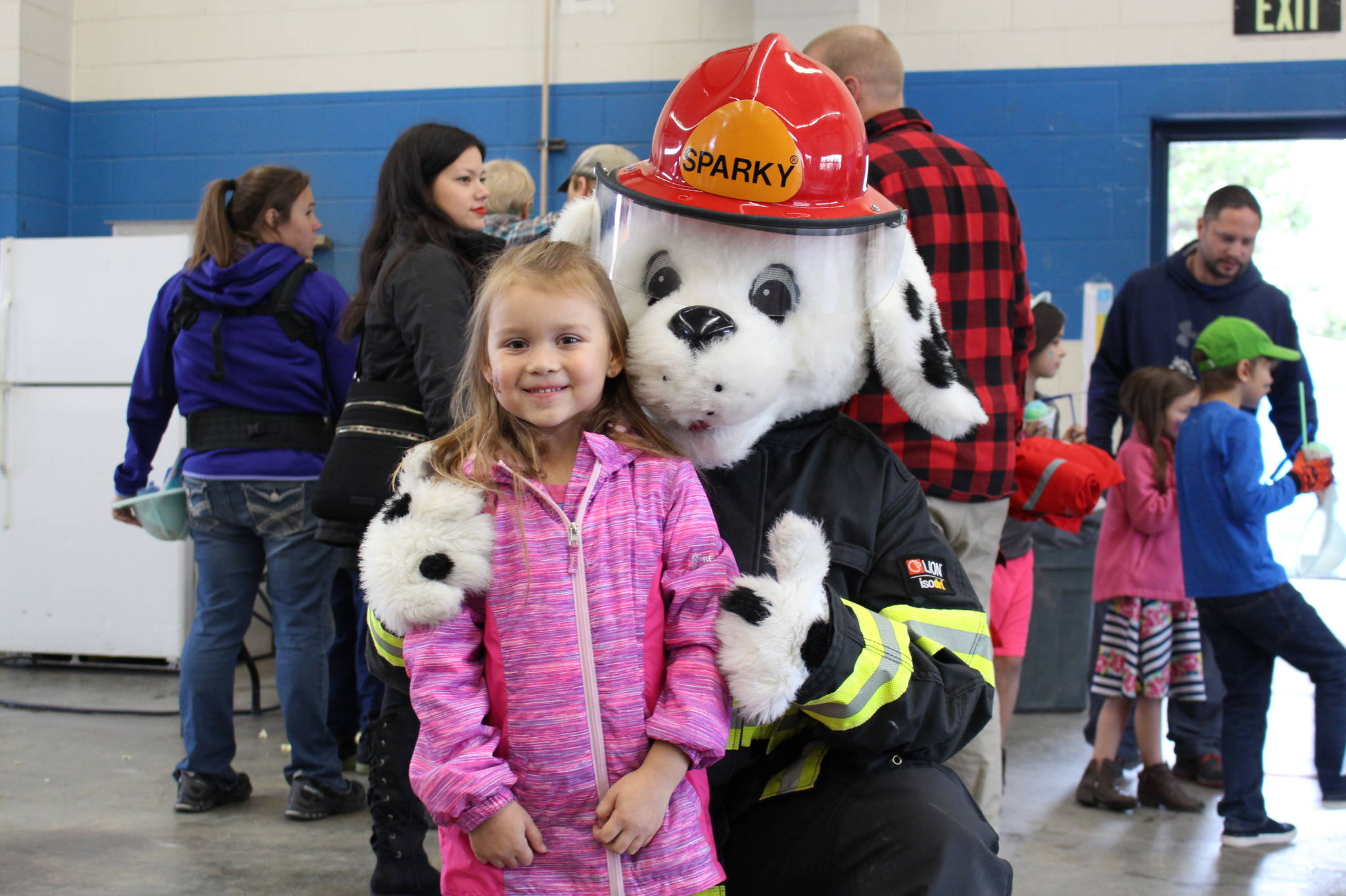 Journie Hoskins-Brendible poses with Sparky the Fire Dog during the Central Emergency Services Open House at Fire Station 1 in Soldotna, Alaska on Sept. 28, 2019. (Photo by Brian Mazurek/Peninsula Clarion)