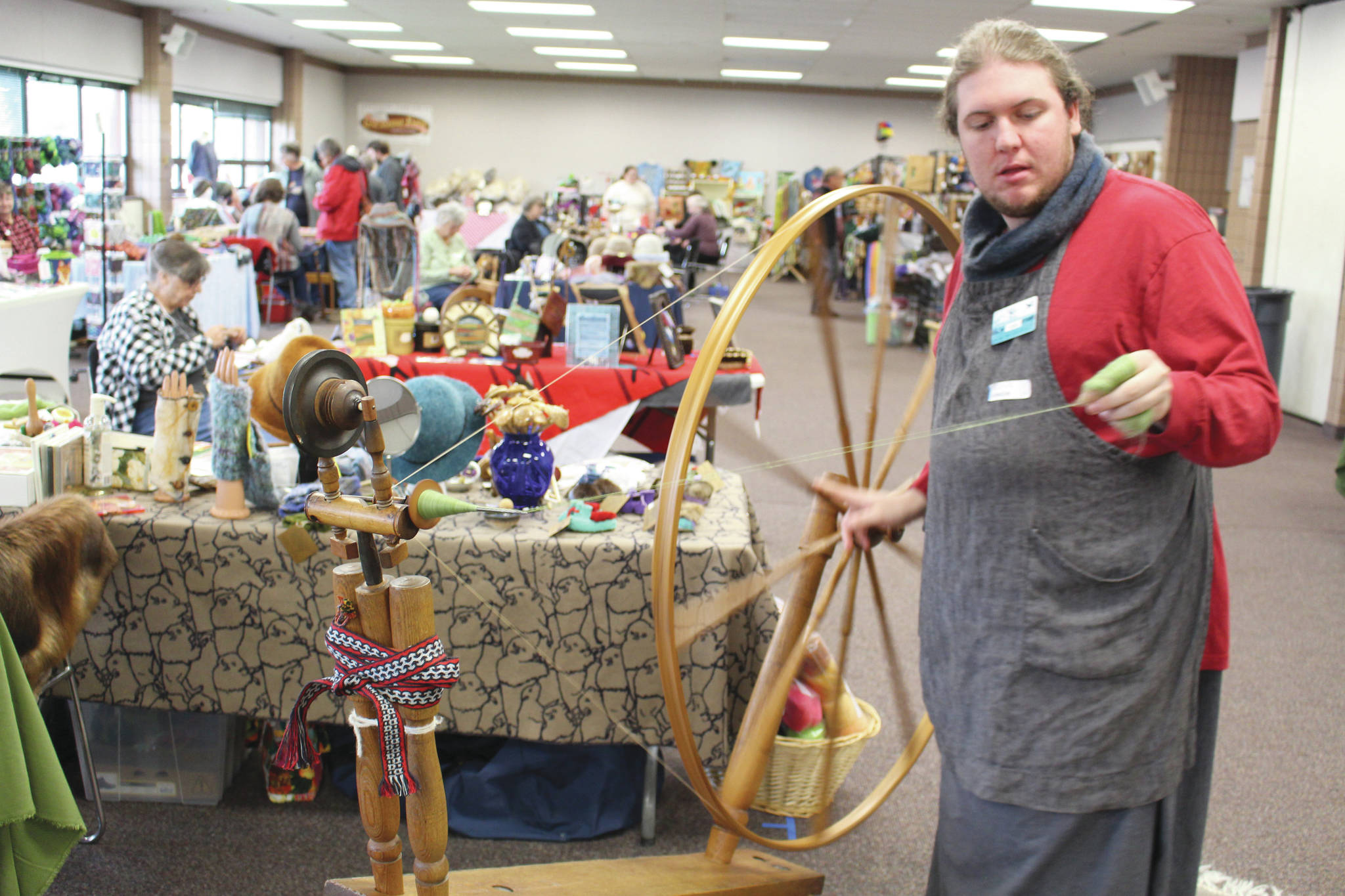 Cole Harmon shows off his great wheel – also known as a muckle wheel – during the Fireweed FiberFest at the Soldotna Regional Sports Complex on Sept. 28, 2019. Harmon spins with qiviut, which is the inner wool of the musk ox and is harvested by Alaska Native elders in Nome. Harmon discovered recently that his wheel was built in the 1750s out of salvaged shipwreck wood by Quakers on the east coast. The wood itself is about 900 years old and was originally harvested in Scotland.