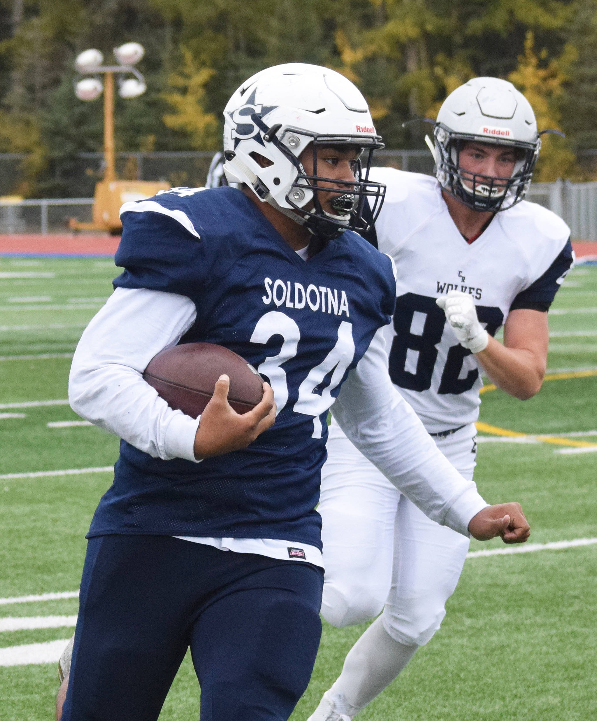 Soldotna’s Aaron Faletoi breaks away from Eagle River defender Samuel Thompson, Saturday, Sept. 28, 2019, against Eagle River at Justin Maile Field in Soldotna. (Photo by Joey Klecka/Peninsula Clarion)
