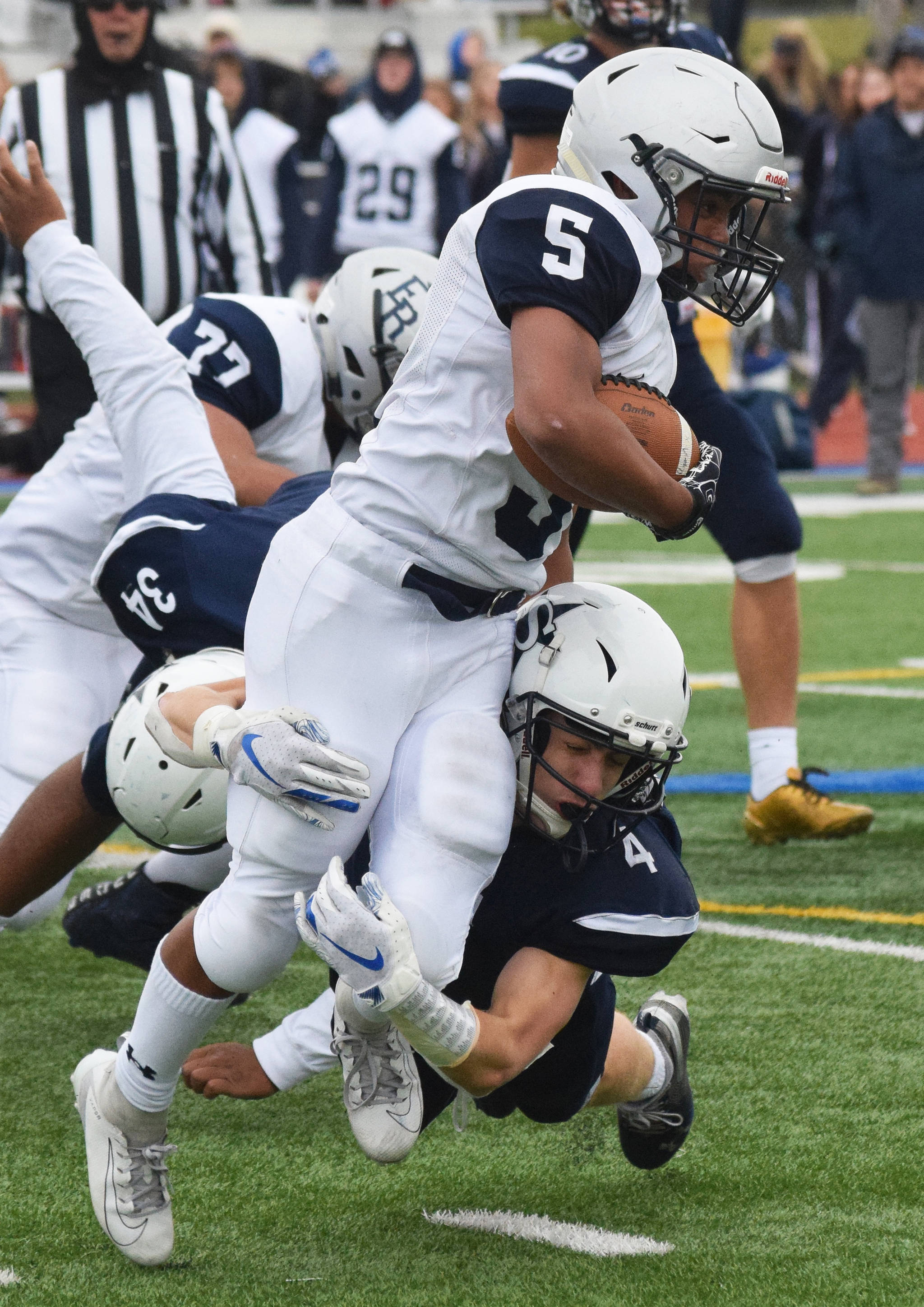 Soldotna’s Jersey Truesdell (bottom) tackles Eagle River’s Cashiez Reaves, Saturday, Sept. 28, 2019, against Eagle River at Justin Maile Field in Soldotna. (Photo by Joey Klecka/Peninsula Clarion)