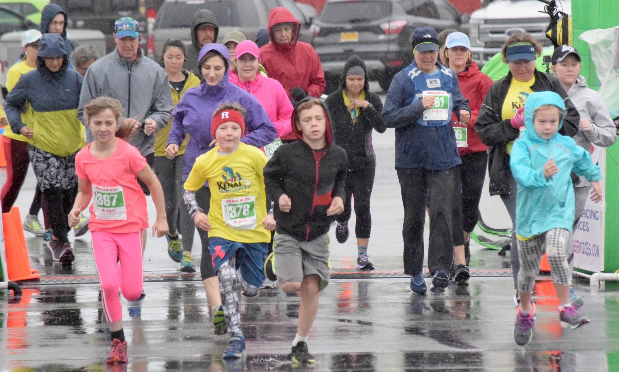 Runners dash from the start of the 5-kilometer race Sunday, Sept. 29, 2019, at the Kenai River Marathon. (Photo by Jeff Helminiak/Peninsula Clarion)