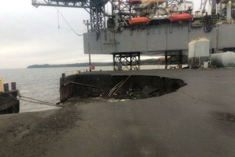 Heavy seas caused an Offshore System Kenai (OSK) earth and fill dock, with fuel lines, to collapse, Oct. 2, 2019, resulting in the discharge of approximately 300 gallons of oil. Inspectors from Coast Guard Marine Safety Detachment Homer responded to the incident and are coordinating with the responsible party and state authorities to mitigate further pollution. The dock continues to erode, but all remaining hazardous materials have been removed. (U.S. Coast Guard courtesy photo)