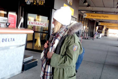 The writer is seen in this ridiculous photo posted immediately to her mother’s Facebook as she leaves for Alaska in February 2017 with only one coat, the army jacket she wears in this photo. (Photo courtesy of Eileen Sorensen)