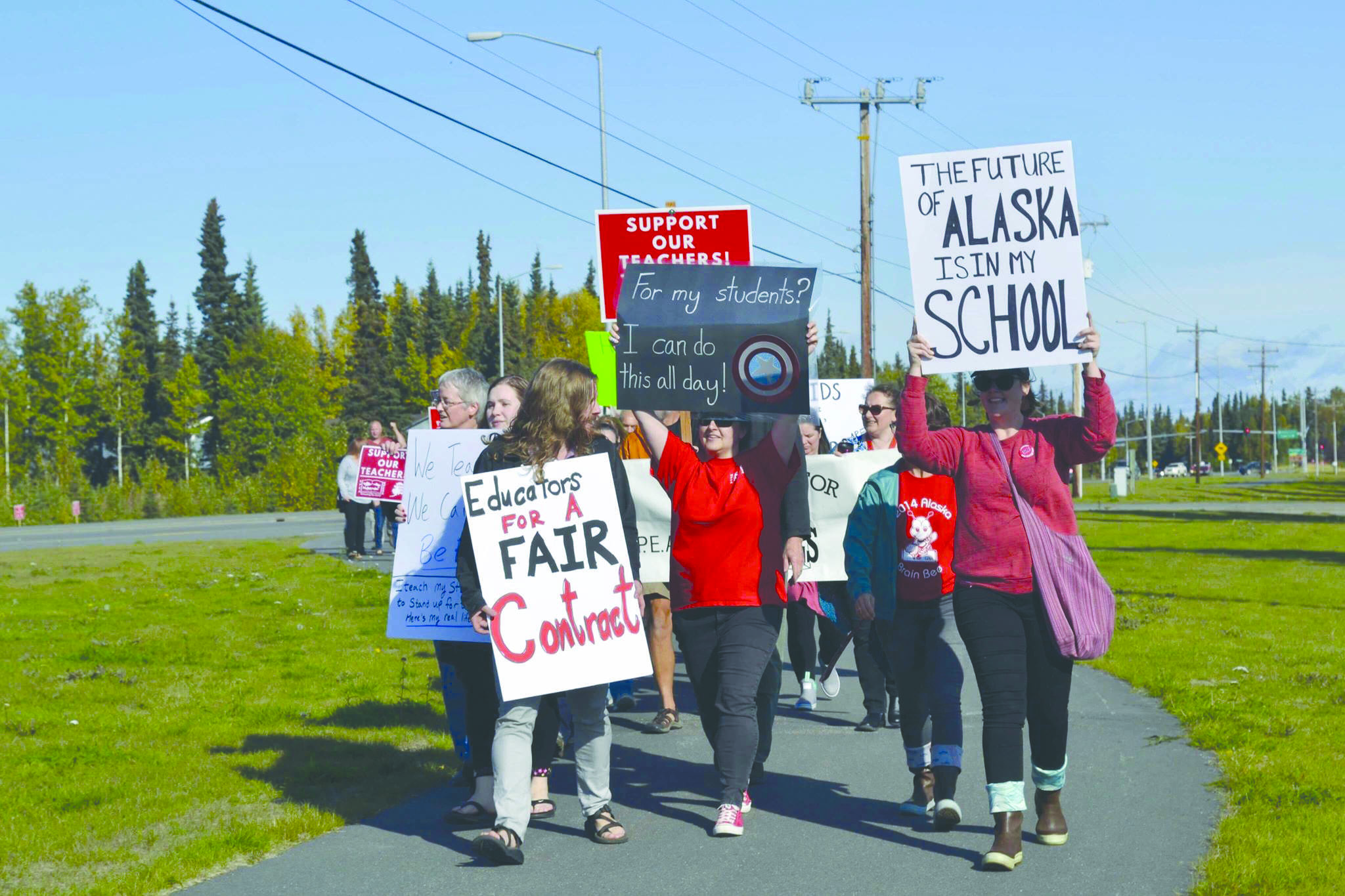 Educators rally in front of Kenai Central High School after school ahead of a strike called on by two employee associations, on Monday, Sept. 16, 2019, in Kenai, Alaska. (Photo by Victoria Petersen/Peninsula Clarion)