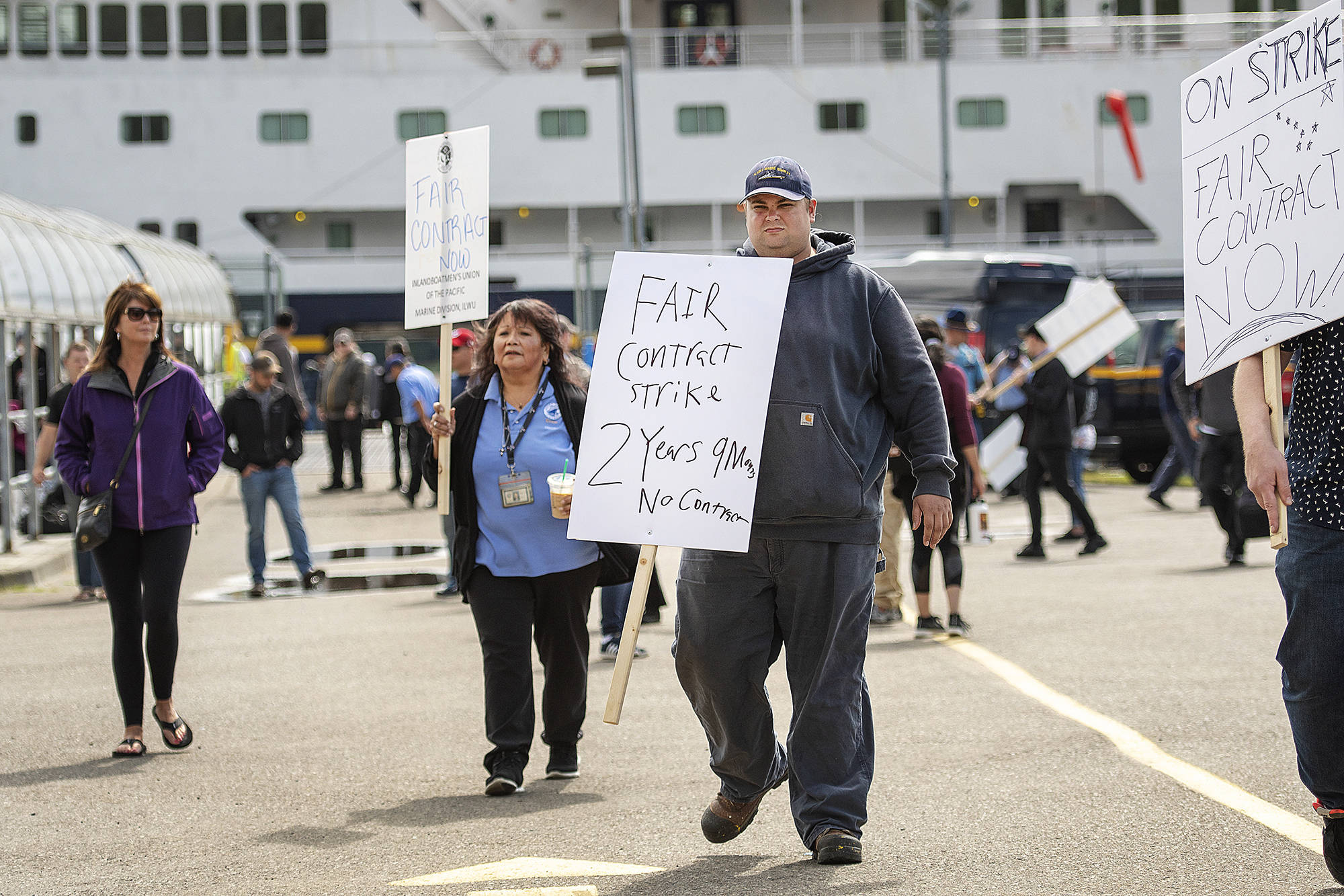 Alaska Marine Highway System workers assemble next to the AMHS ferry Columbia for an Inlandboatmen’s Union of the Pacific strike after failing to reach agreement on a contract with the state of Alaska, Wednesday, July 24, 2019, in Ketchikan, Alaska. (Dustin Safranek/Ketchikan Daily News via AP)