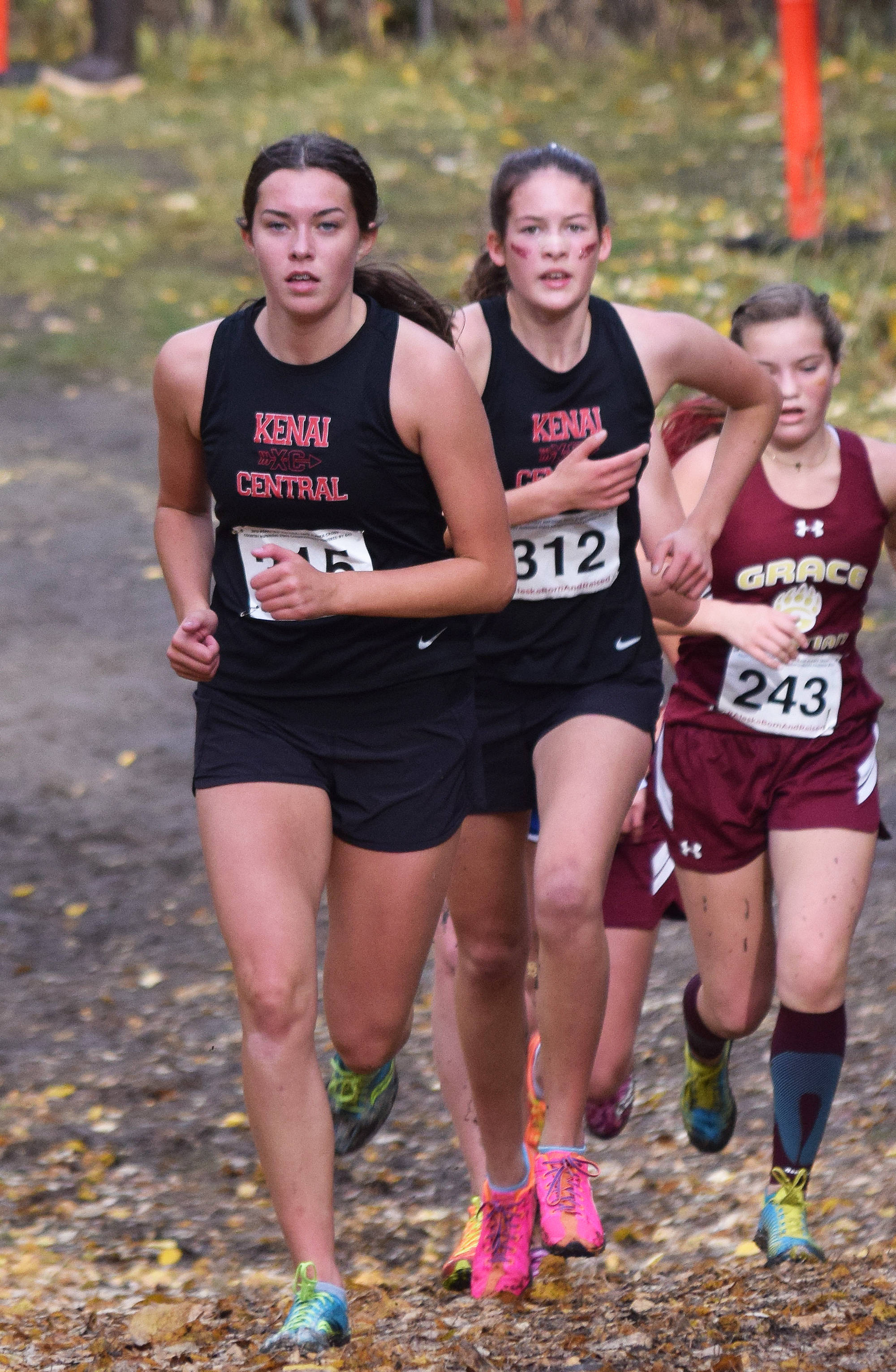 Kenai Central teammates Logan Satathite (front) and Leah Fallon race together in the Div. II girls state cross-country championships Saturday, Oct. 5, 2019, on the Bartlett High trails in Anchorage, Alaska. (Photo by Joey Klecka/Peninsula Clarion)