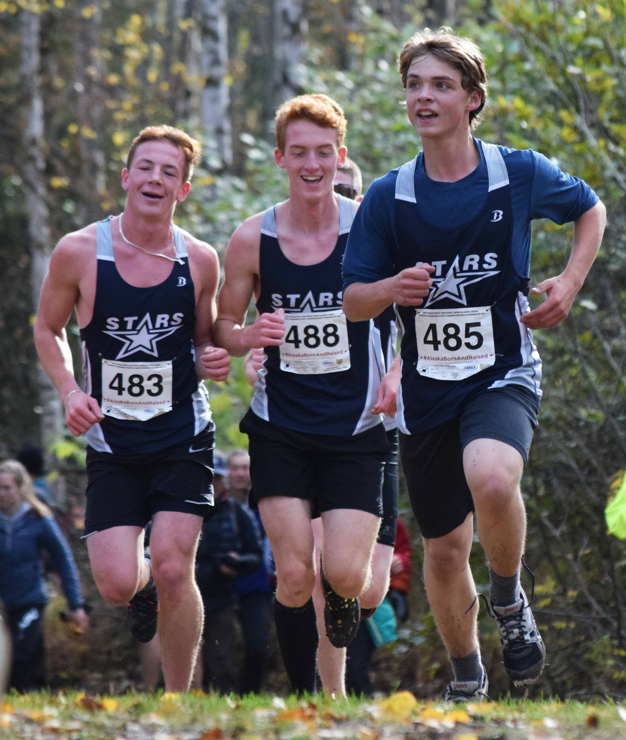 The Soldotna trio of Zachary Burns (left), Anchor Musgrave (middle) and Quinn Cox run for position in the Div. I boys state cross-country championships Saturday, Oct. 5, 2019, on the Bartlett High trails in Anchorage, Alaska. (Photo by Joey Klecka/Peninsula Clarion)