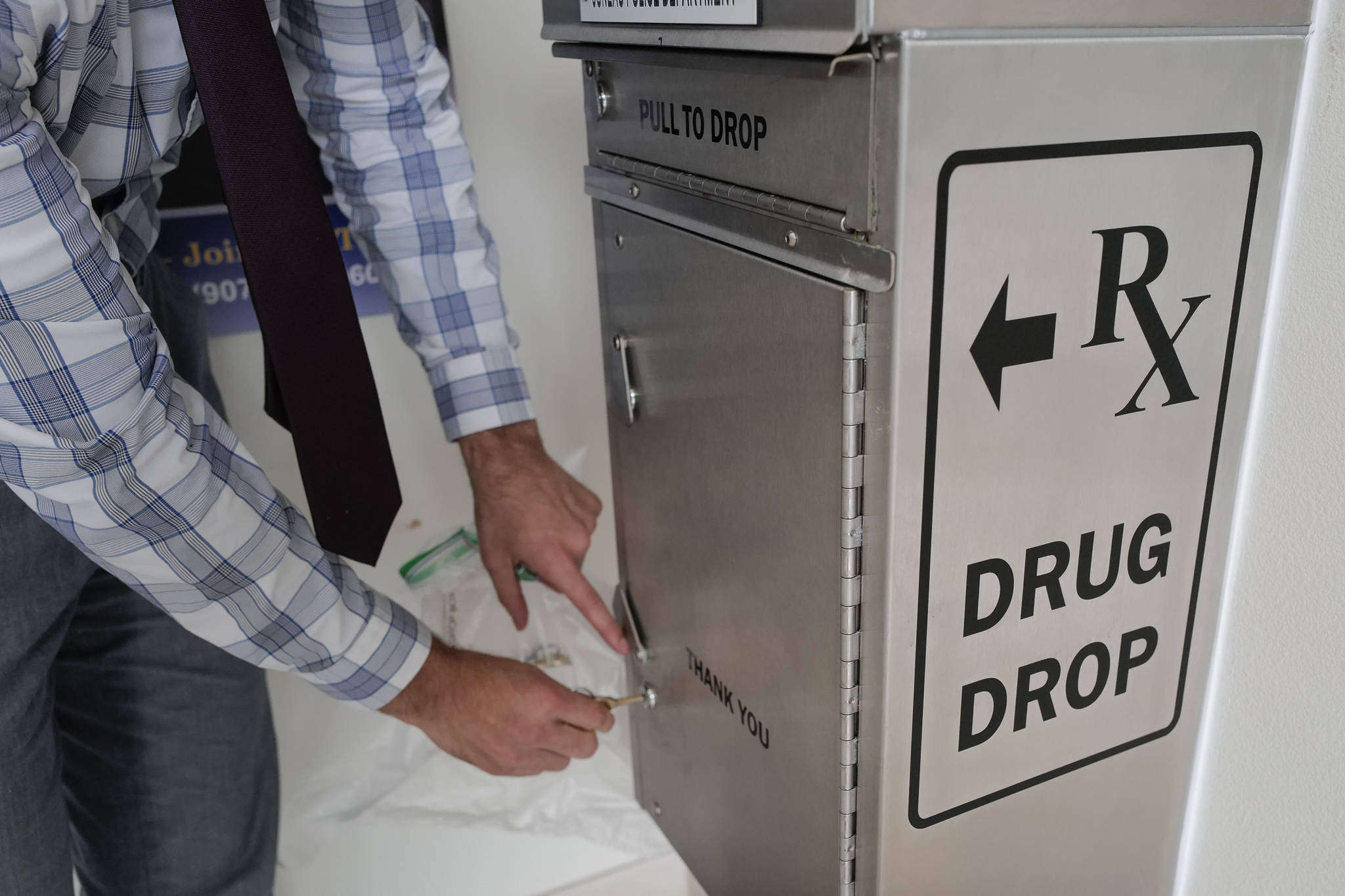 Lt. Jeremy Weske opens a drug drop box in the lobby of the Juneau Police Department on Thursday, Sept. 26, 2019. The drop box gives residents a safe place to disposed of their unused prescription narcotics. (Michael Penn | Juneau Empire)