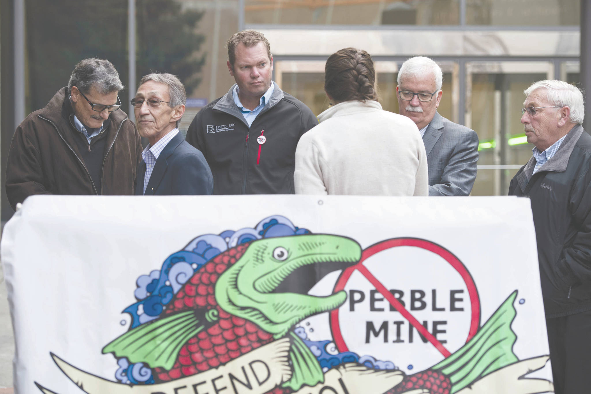 From left, Bristol Bay Reserve Association Board member Mike LaRussa, Bristol Bay Native Association President/CEO Ralph Andersen, Bristol Bay Regional Seafood Development Association Executive Director Andy Wink, United Tribes of Bristol Bay Deputy Director Lindsay Layland, Bristol Bay Economic Development Corporation President and CEO Norm Van Vactor, and Robin Samuelson of Bristol Bay Native Corporation, make statements at the Federal Courthouse in Anchorage, Alaska Tuesday Oct. 8, 2019. Critics of the Pebble Mine planned near headwaters of a major Alaska salmon fishery are suing the U.S. Environmental Protection Agency, saying EPA improperly withdrew proposed restrictions on development in that region. (Marc Lester/Anchorage Daily News via AP)