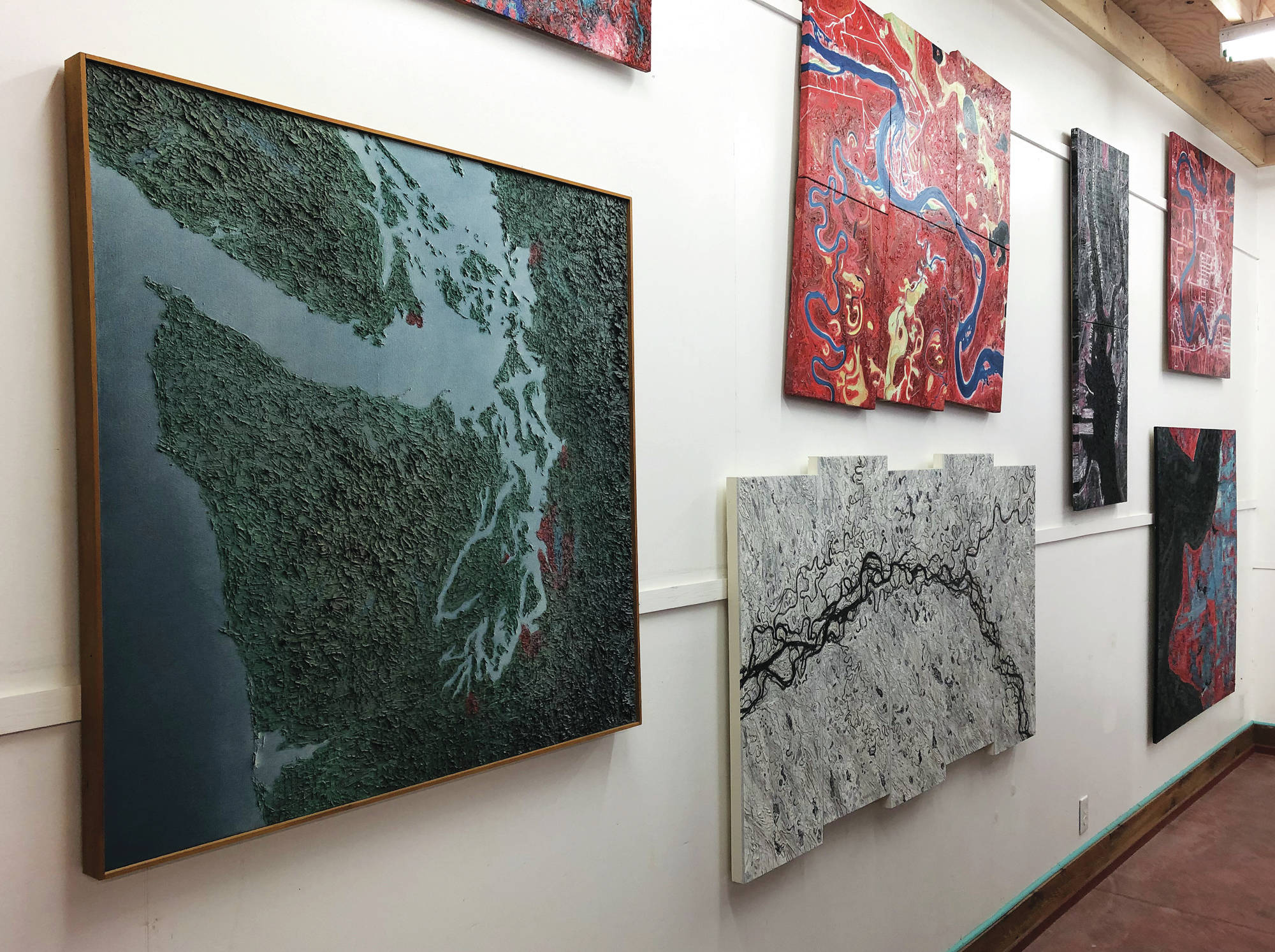 Paintings by Spelman Evans Downer sit on display at the Ecotopia North Painting Exhibition at the Gallery Turquoise North at mile 49.5 of the Sterling Highway in Cooper Landing. (Photo provided by Sara Frantz)