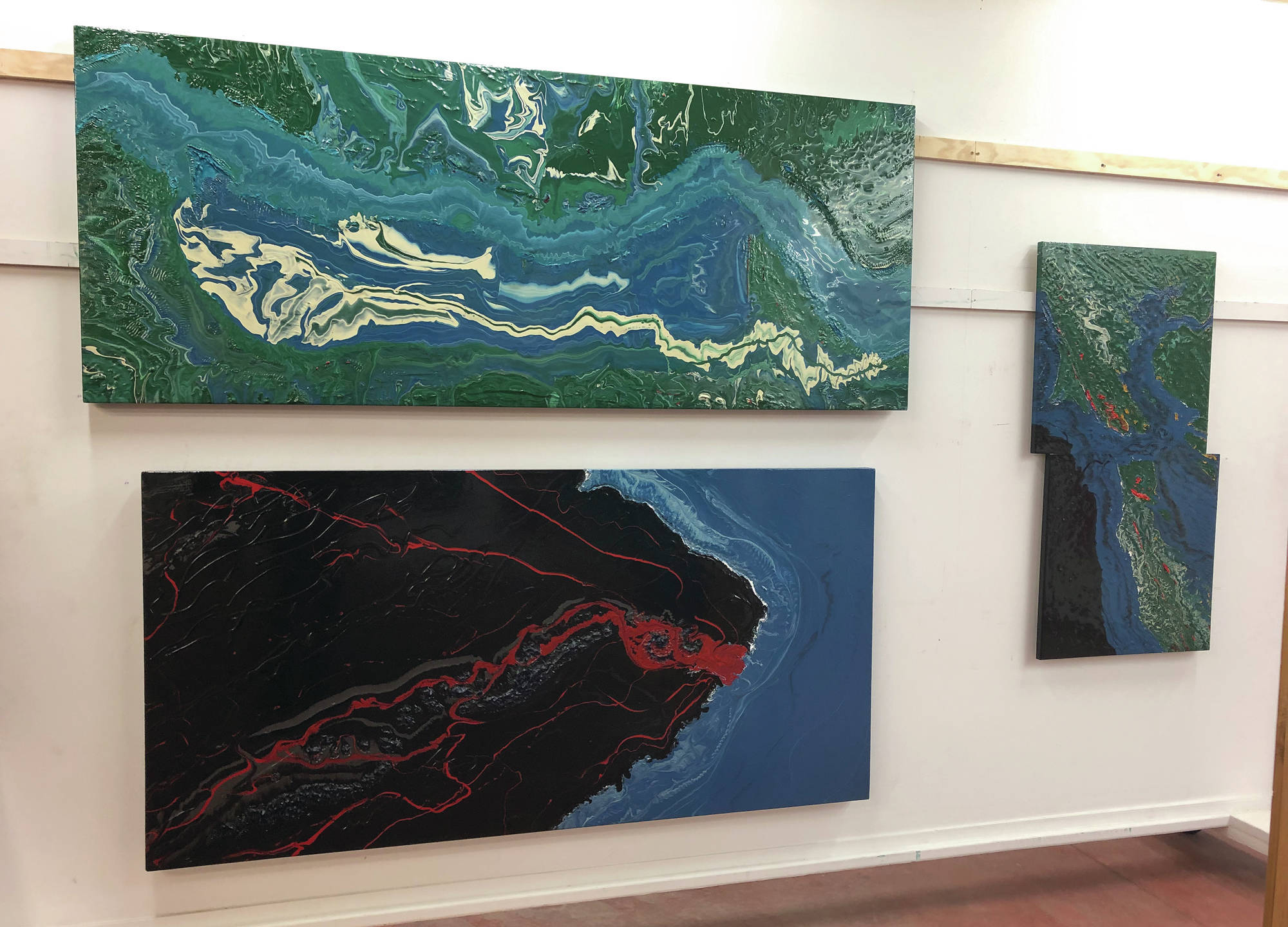 Paintings by Spelman Evans Downer sit on display at the Ecotopia North Painting Exhibition at the Gallery Turquoise North at mile 49.5 of the Sterling Highway in Cooper Landing. (Photo provided by Sara Frantz)