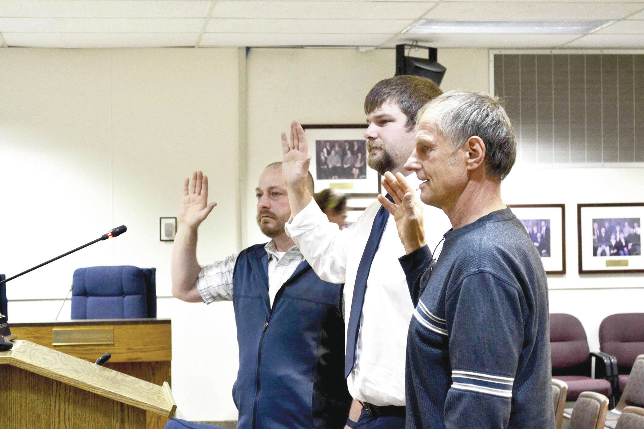 Newly elected assembly members Tyson Cox (left), Jesse Bjorkman (center) and Brent Johnson are sworn in during Tuesday’s Kenai Peninsula Borough Assembly meeting, Tuesday, Oct. 8, 2019, in Soldotna, Alaska. (Photo by Victoria Petersen/Peninsula Clarion)