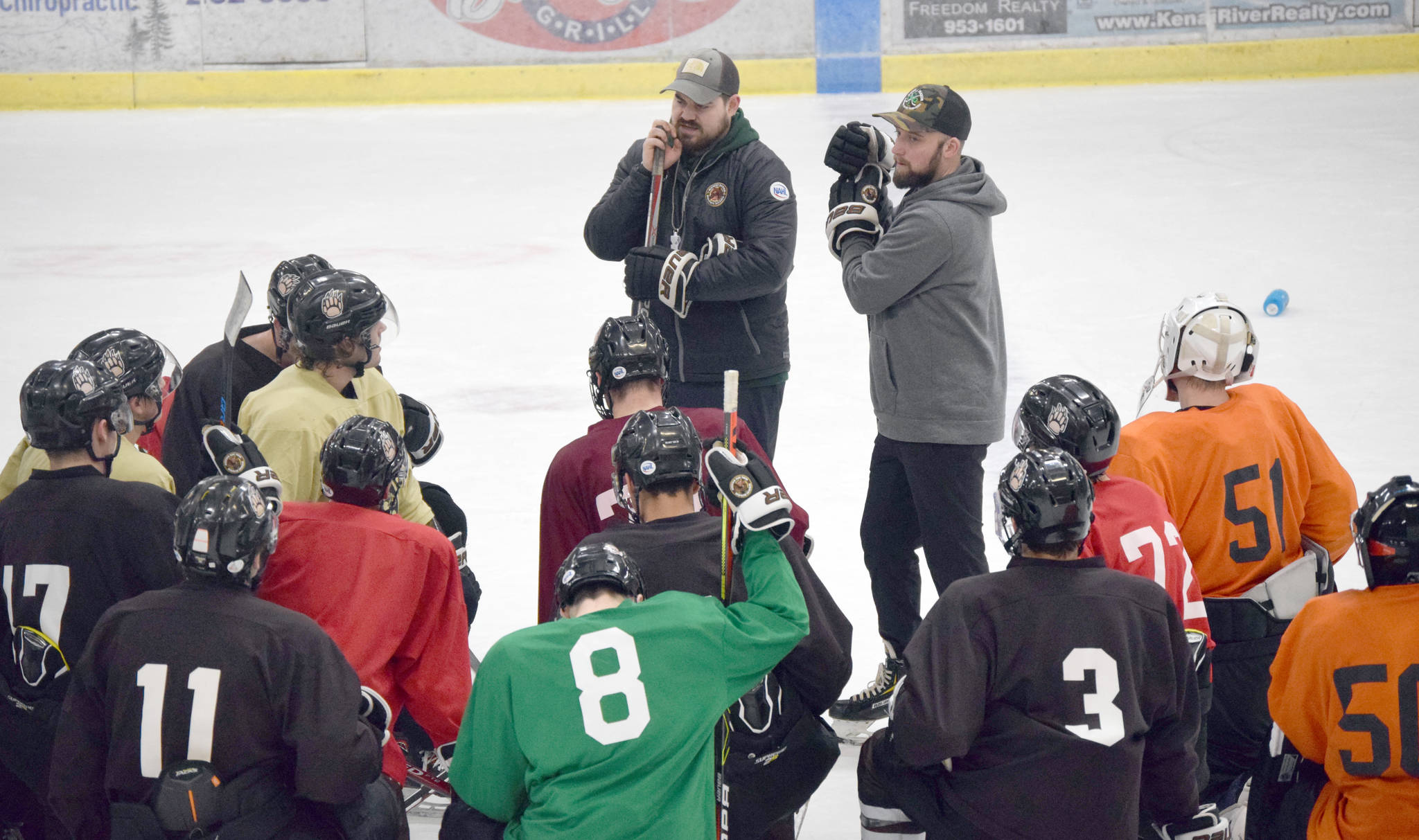 Kenai River Brown Bears head coach Kevin Murdock and associate head coach Dan Bogdan address the team during practice Wednesday, Oct. 9, 2019, at the Soldotna Regional Sports Complex in Soldotna, Alaska. (Photo by Jeff Helminiak/Peninsula Clarion)