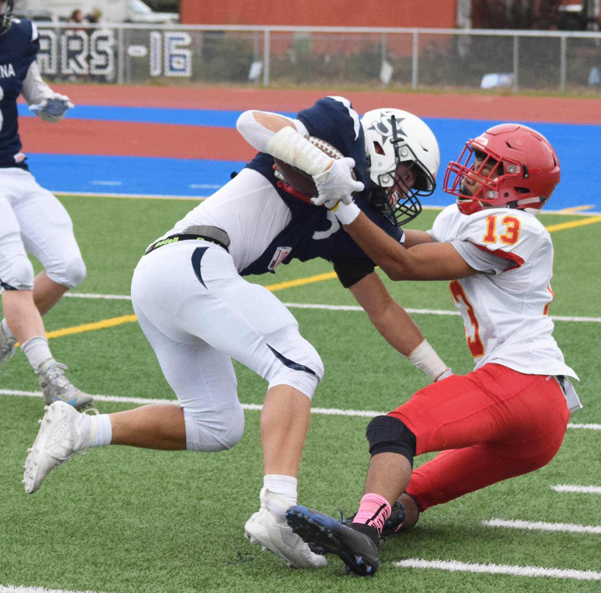 Soldotna’s Hudson Metcalf is tackled to the ground by West Valley’s Tyriq Nance in a Div. II state semifinal Friday, Oct. 11, 2019, in Soldotna, Alaska. (Photo by Joey Klecka/Peninsula Clarion)