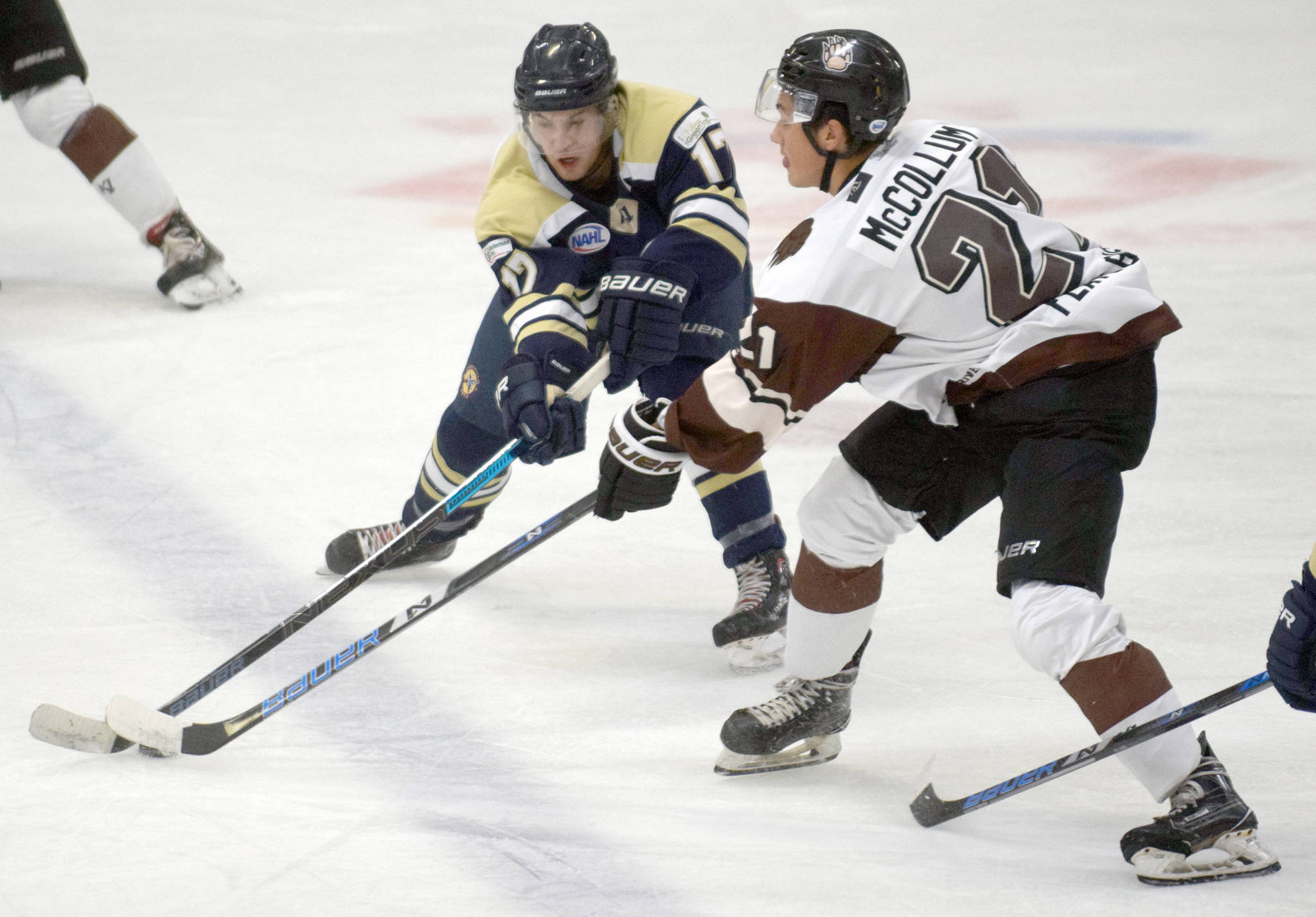Luke Wheeler of the Janesville (Wisconsin) Jets and Robert McCollum of the Kenai River Brown Bears battle for the puck on Friday, Oct. 11, 2019, at the Soldotna Regional Sports Complex in Soldotna, Alaska. (Photo by Jeff Helminiak/Peninsula Clarion)
