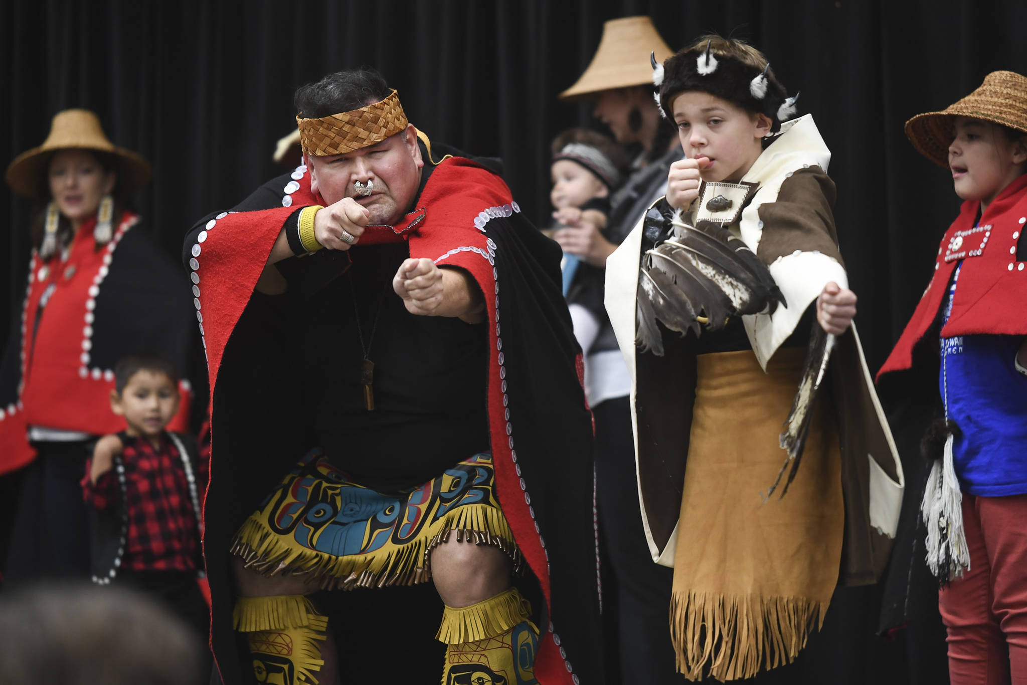 Alfie Price, left, and Tristen Washington, 9, perform with the Xaadaas Dagwii Dance Group for Indigenous Peoples’ Day at the Elizabeth Peratrovich Hall on Monday, Oct. 14, 2019. (Michael Penn | Juneau Empire)