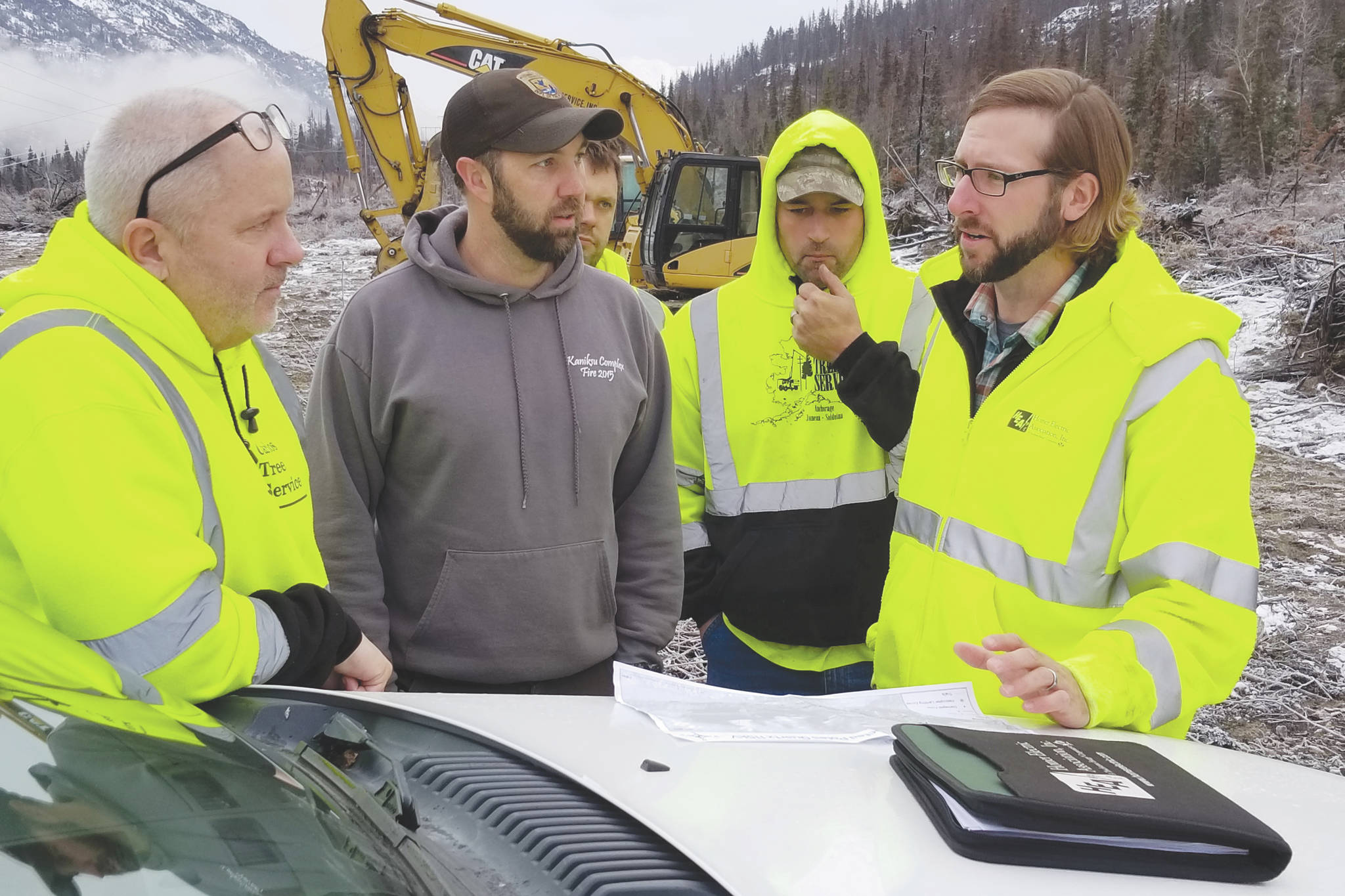 HEA Land Management Officer Cody Neuendorf and Mike Hill, Kenai Wildlife Refuge assistant fire management officer, brief clearing contractor on fire-related hazards before starting danger tree mitigation along the “S/Q Line” Right of Way. (Courtesy photo)