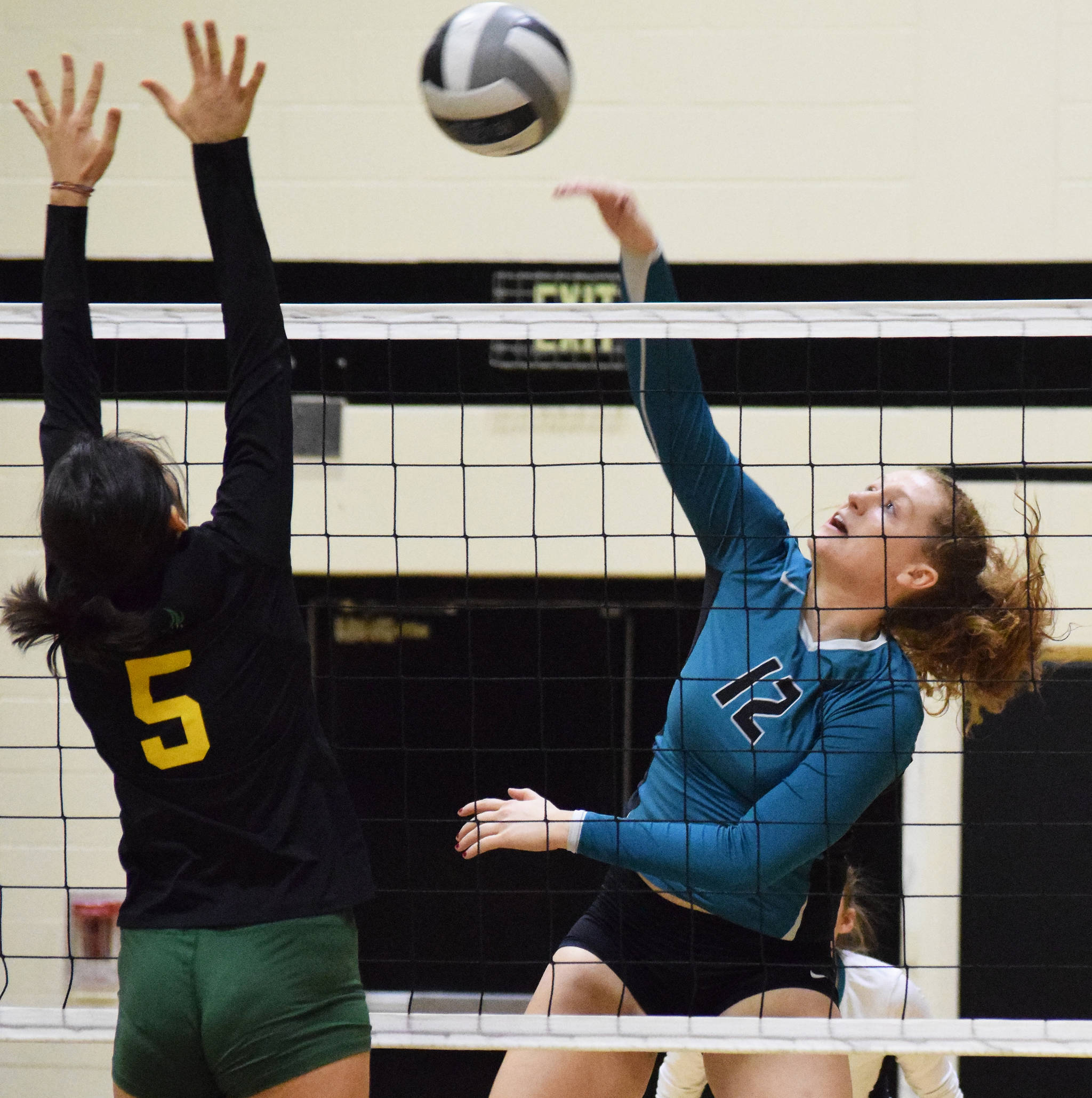 Nikiski’s Kaycee Bostic unleashes a shot over Seward’s Sofia Perazzi, Thursday, Oct. 17, 2019, at Nikiski High School in Nikiski, Alaska. (Photo by Joey Klecka/Peninsula Clarion)