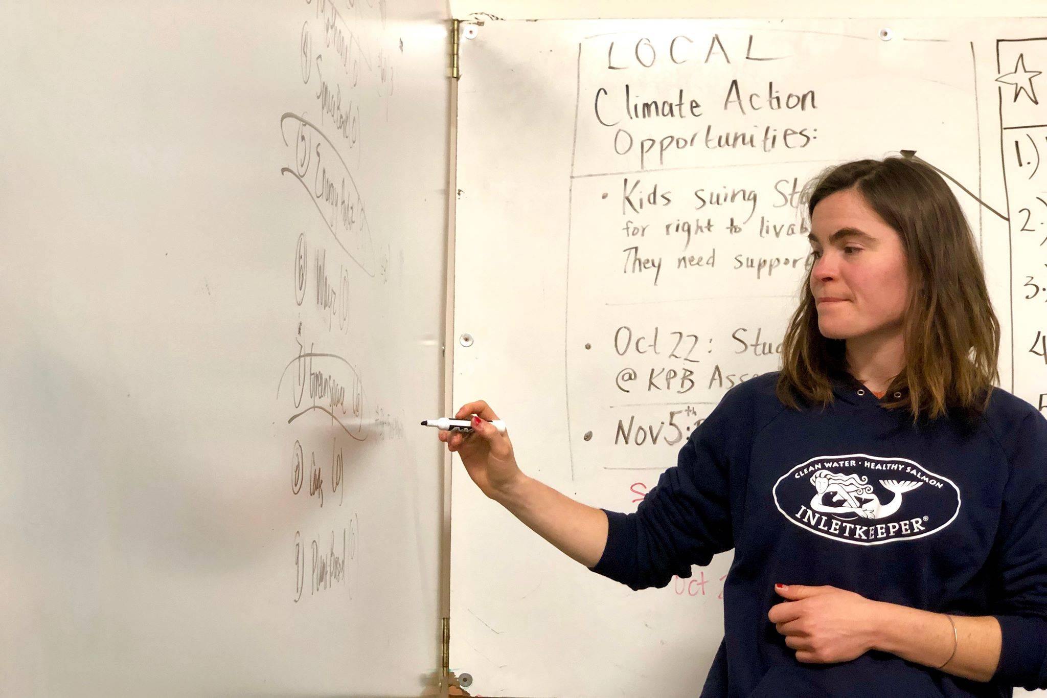 Kaitlin Vadla, Kenai regional director of Cook Inletkeeper, keeps track of community members votes at the final community Drawdown: Climate Series event, Tuesday, Oct. 15, 2019, near Soldotna, Alaska. (Photo by Victoria Petersen/Peninsula Clarion)